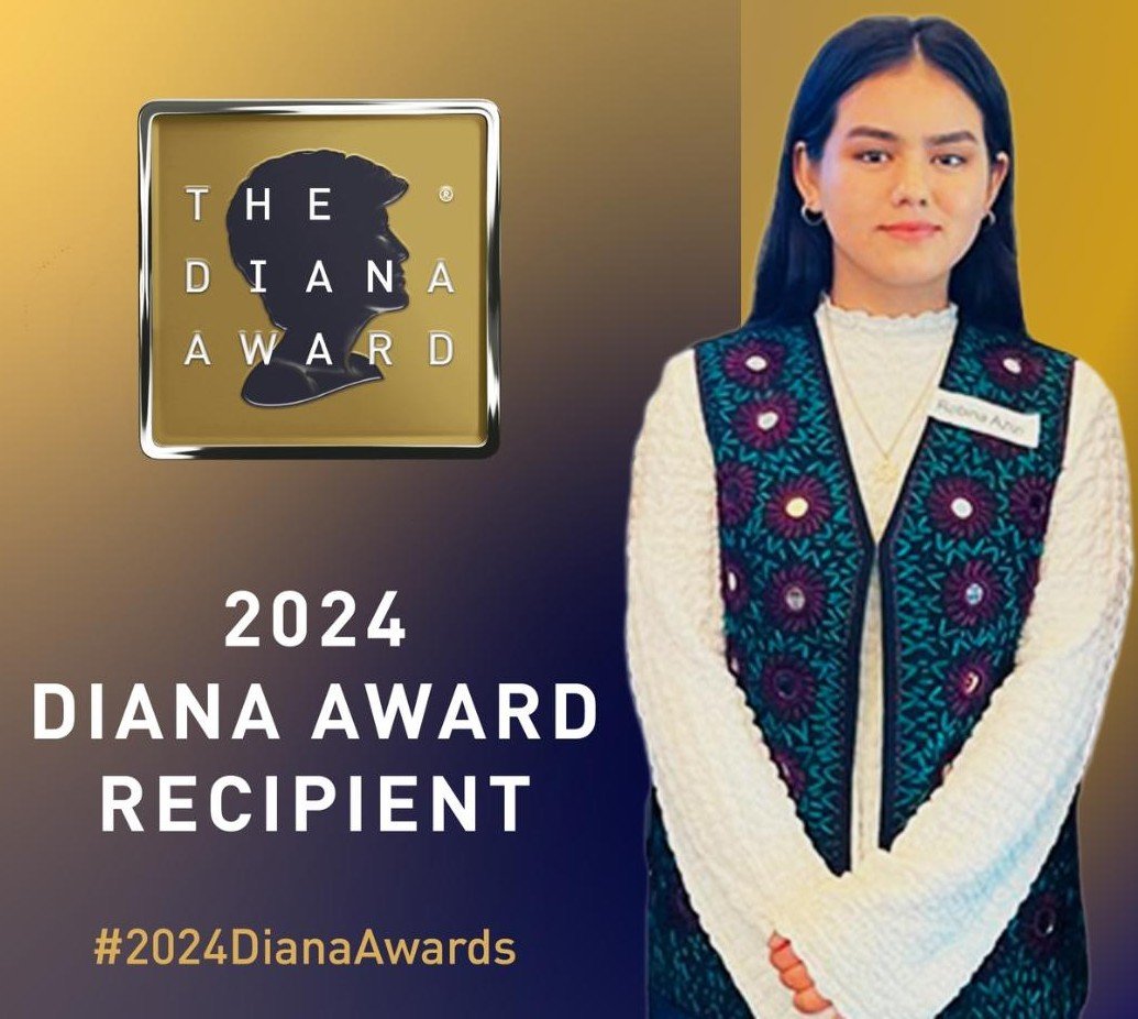 A woman with long dark hair wearing a white textured sweater and a dark vest with colorful floral embroidery, standing next to a logo of The Diana Award with a silhouette profile of Princess Diana, and the text '2024 Diana Award Recipient' along with the hashtag #2024DianaAwards.