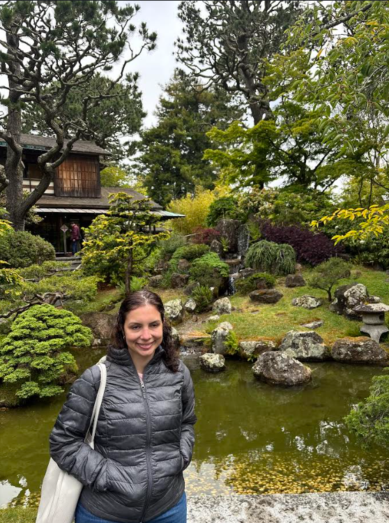Marisol standing in front of a garden