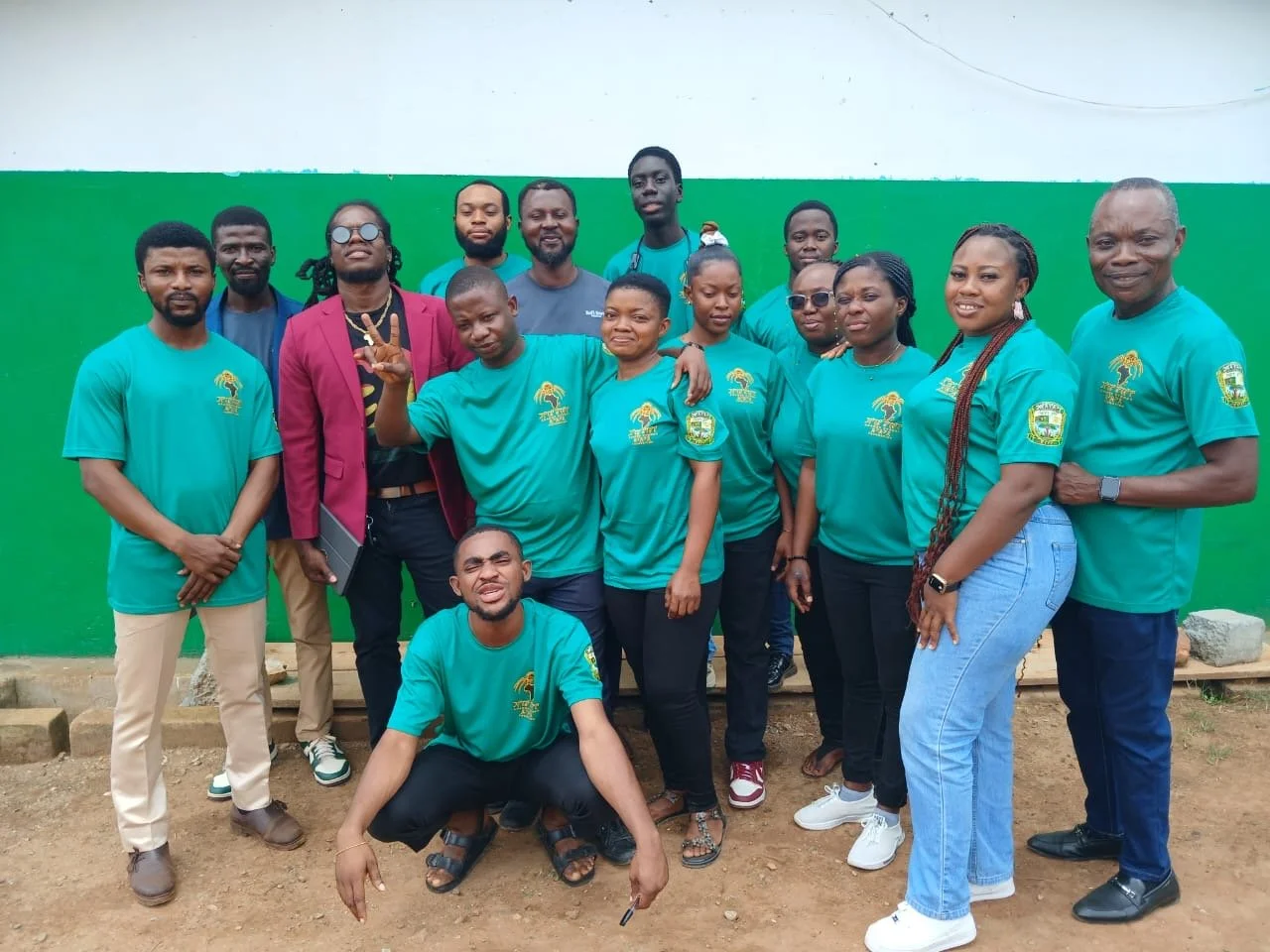 Group compose of Ananse Stroke creator K. Ogyakra, Ghana Director Kofi Dorh, Manager Kwasi Anasah, and the teachers of Evergreen in Aburi, Ghana posing for picture after a successful launch of Ananse Stroke, smiling and making various gestures.