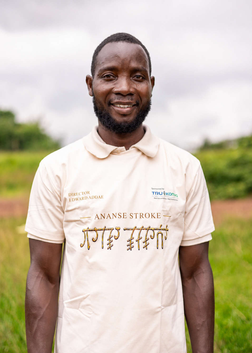 Man wearing an Ananse Stroke shirt outdoors, representing the Ananse Stroke Foundation and its cultural education mission.