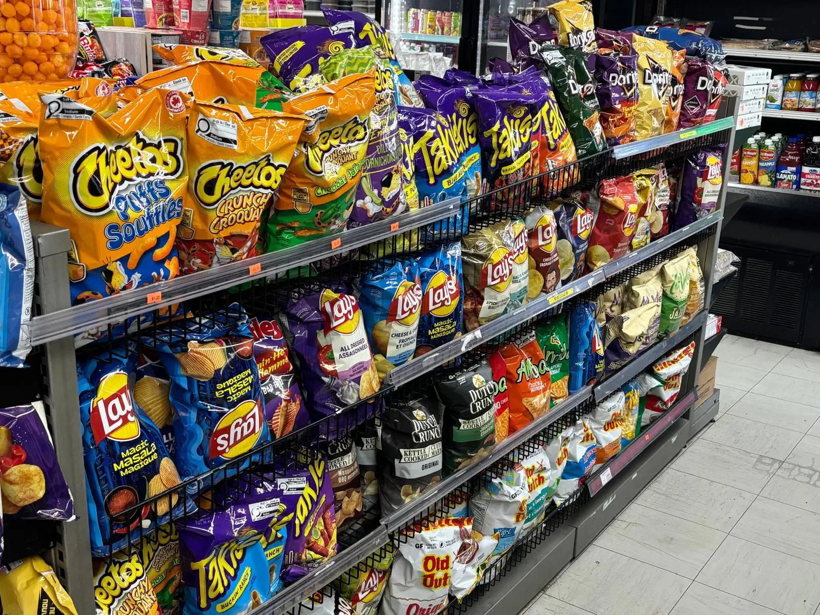 Snack aisle featuring a variety of potato chips and popular snack brands at Athlon Food Store in Edmonton.