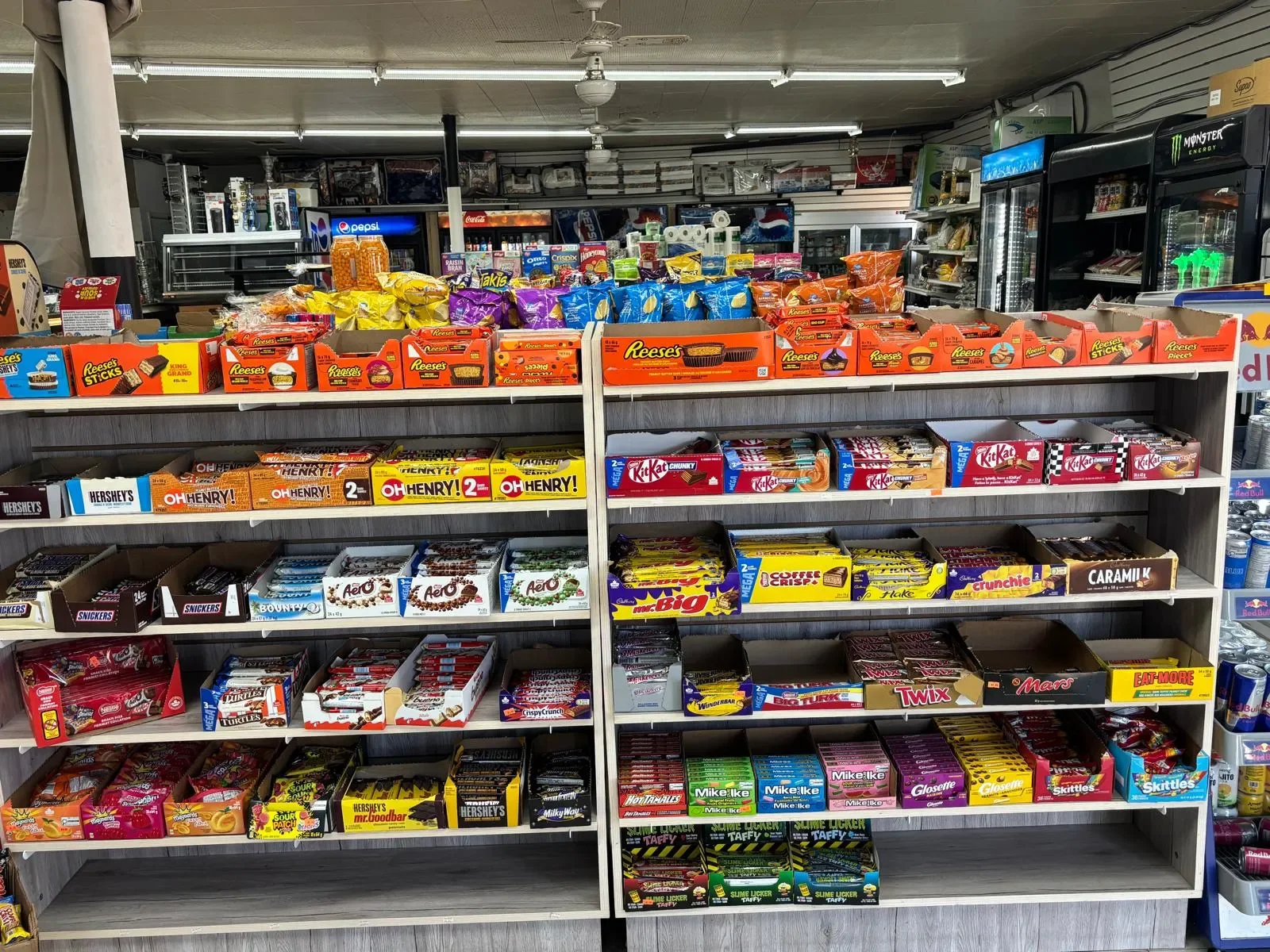 Candy display featuring a variety of chocolates, chewing gum, and sweet treats available at Athlon Food Store in Edmonton.