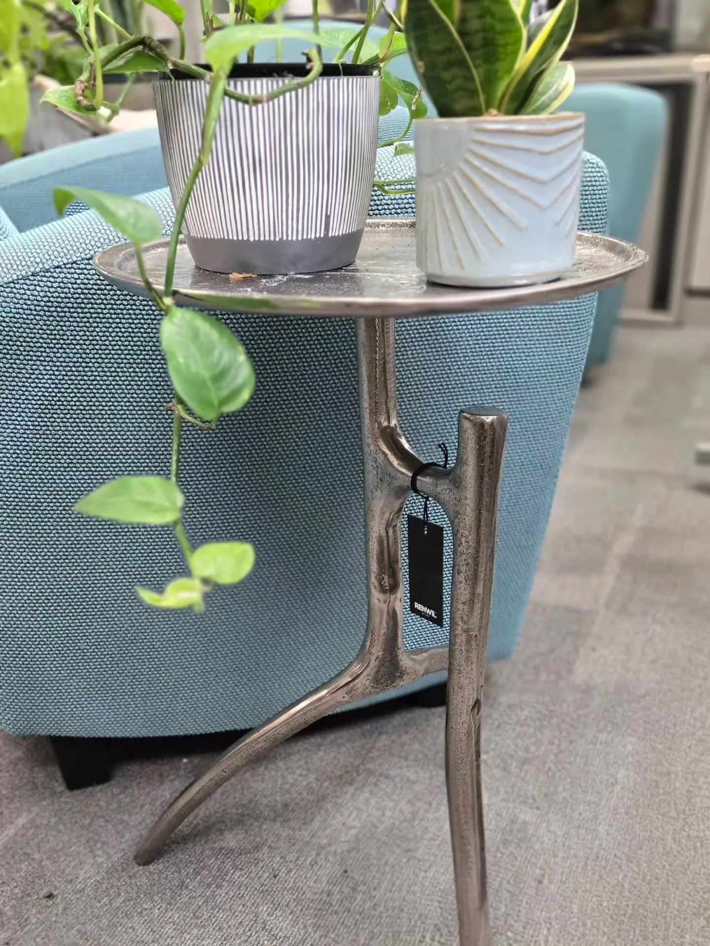 Organic steel side tables lend that treat for the eye. Perfect for plants! This is the same table in 2 different finishes.