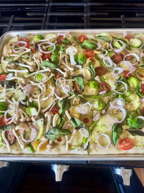 Unbaked vegetable and mushroom casserole in a metal baking dish