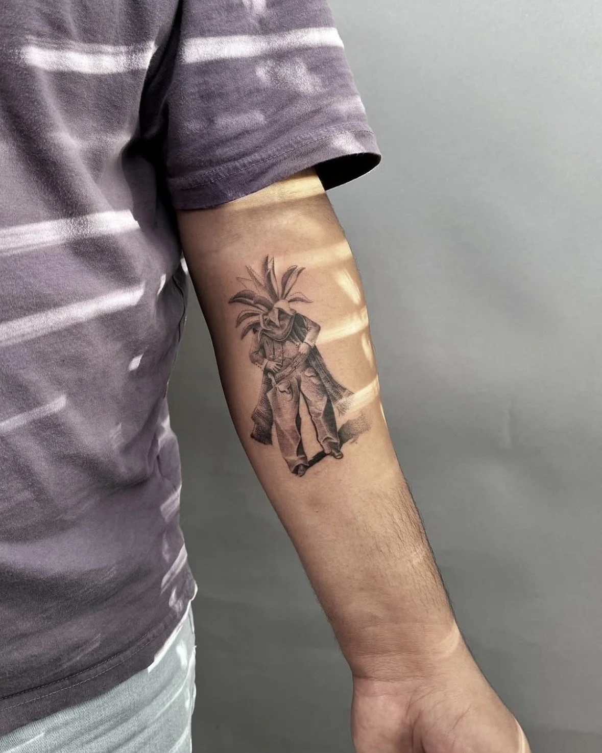 A hyper realistic tattoo done by Ihor (flowerhead.ink) on person's forearm. Featuring a cowboy with a mezcal for a head (flowerhead), wearing a traditional cowboy outfit.
