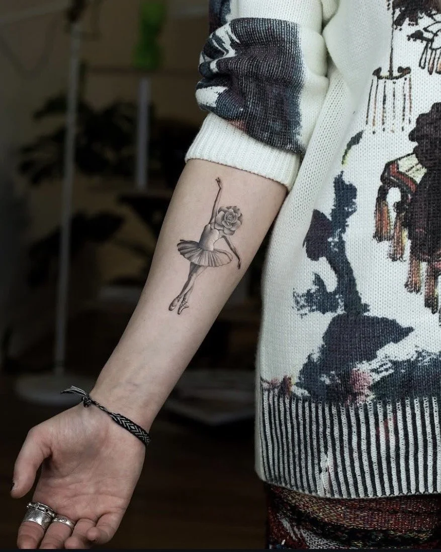 A hyper realistic tattoo done by Ihor (flowerhead.ink) on person's forearm. Featuring a dancing ballerina with a rose as her head (flowerhead).