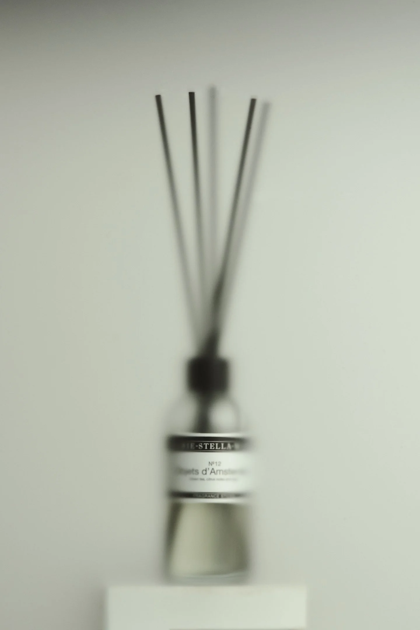 Close-up of a wine bottle, labels partially visible, with a blurred background
