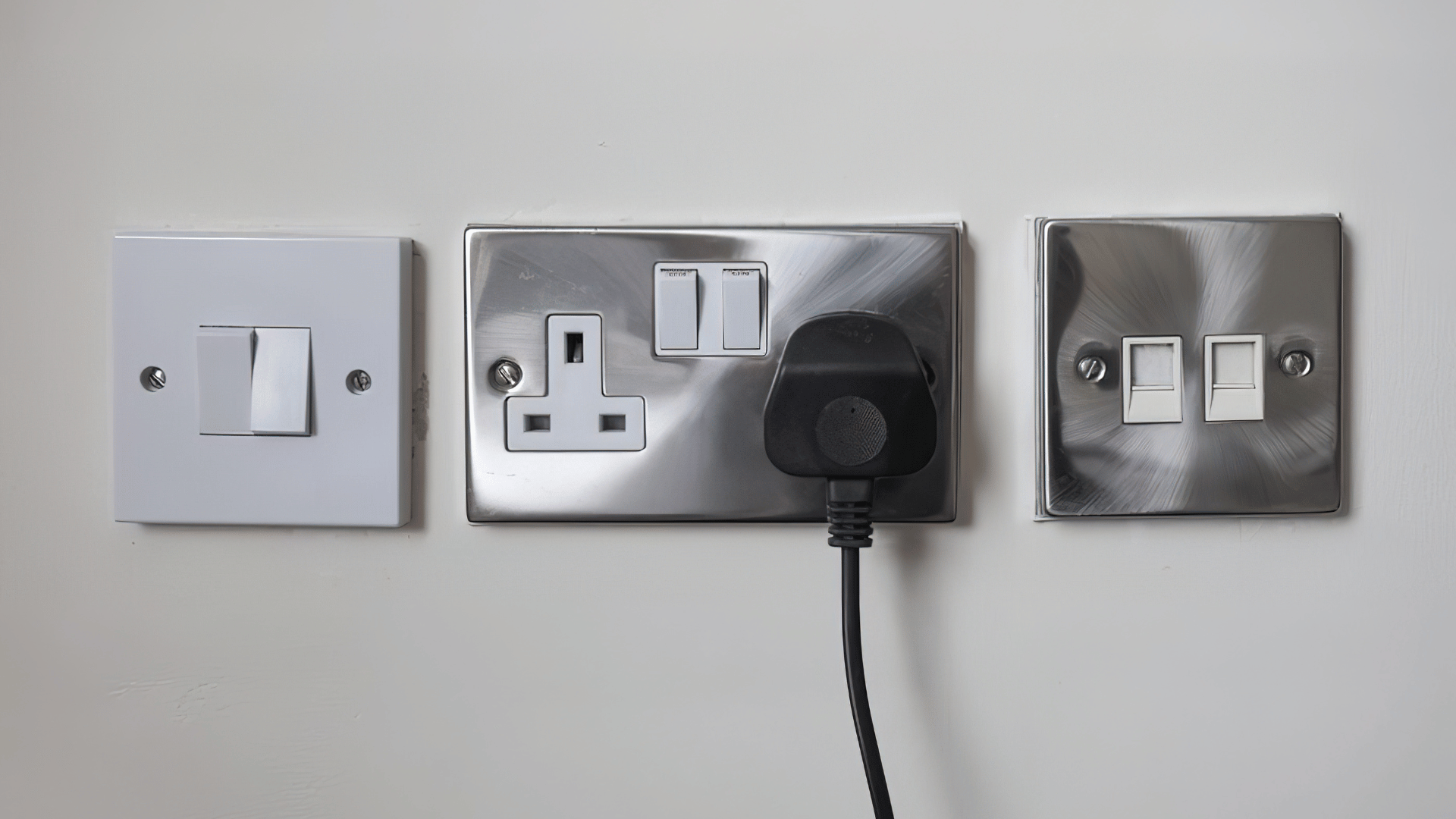 Plug socket and switch on wall