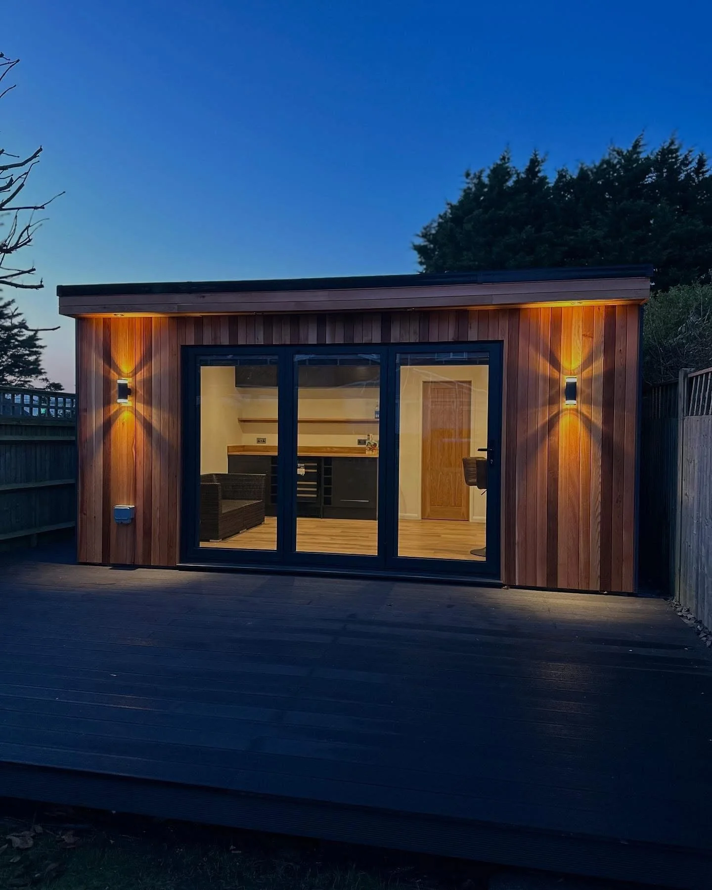 Cabin in garden with outside lights on