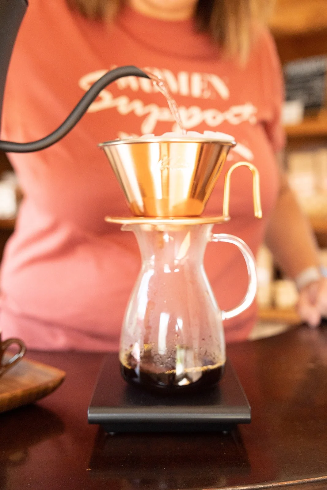 a coffee pour over being prepared at the slow bar using a scale and tsubame dripper