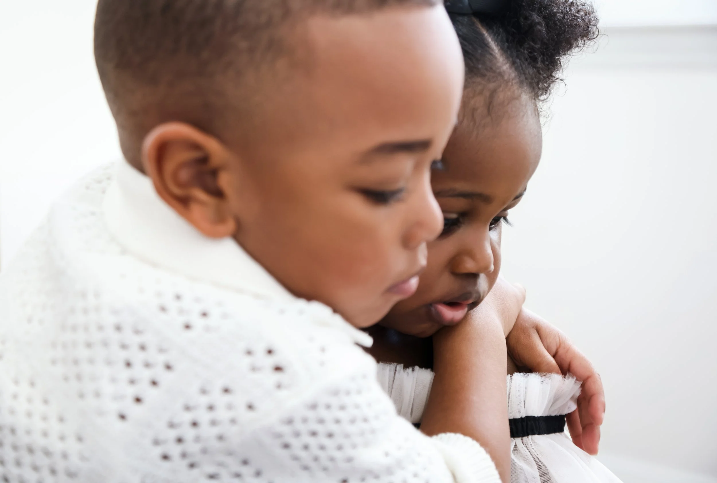 Close-up of two young girls hugging each other.
