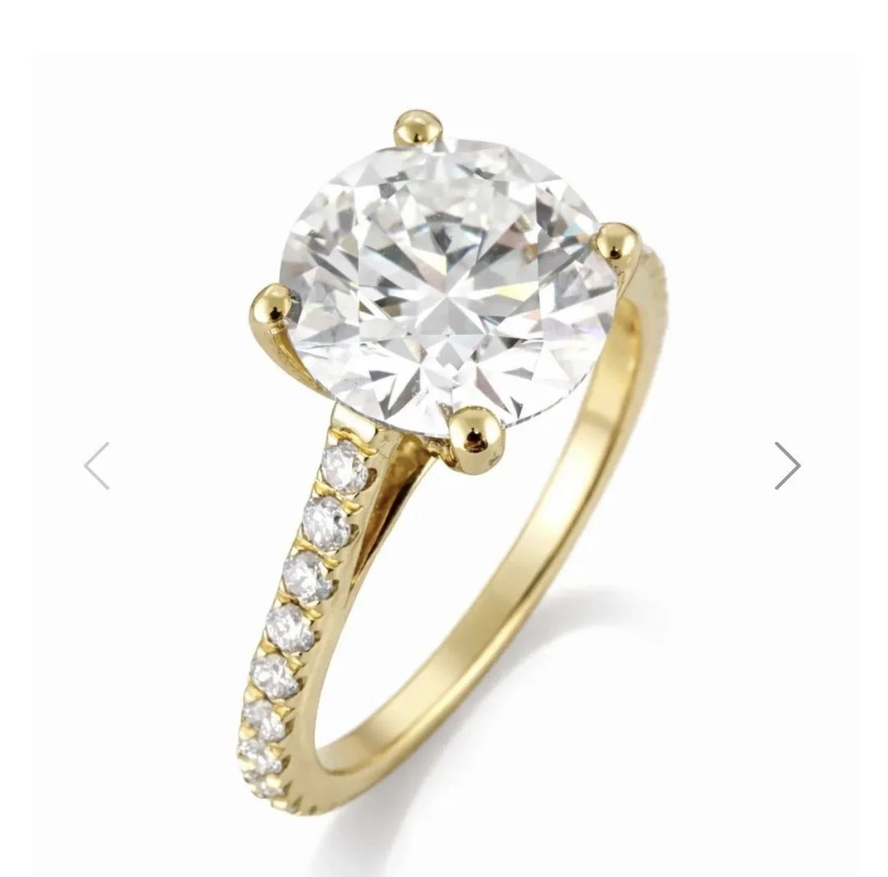Gold ring with a large central diamond and smaller diamonds on the band.