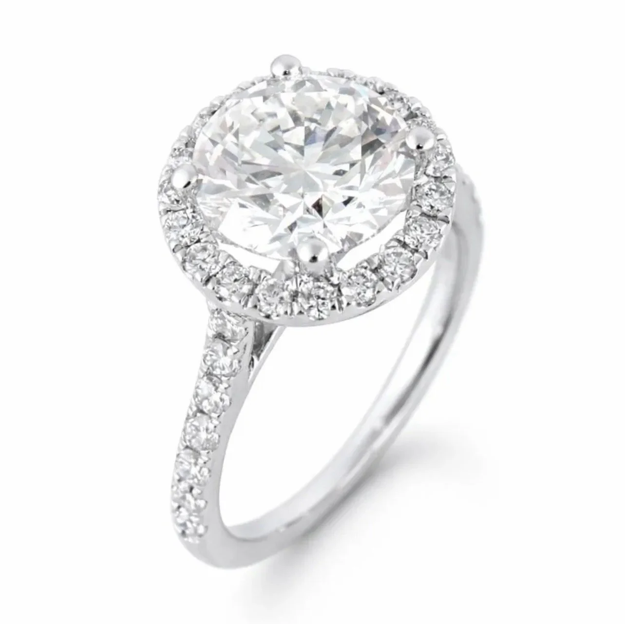 Silver ring with a large round diamond center and smaller diamonds on the band and around the center stone, on a white background.