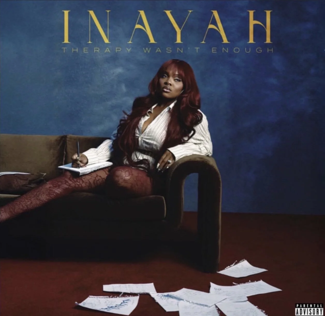Album cover featuring a woman with long red hair, sitting on a couch with papers scattered on the floor in front. The background displays the title 'Inayah' with the subtitle 'The Therapy Wasn't Enough'.