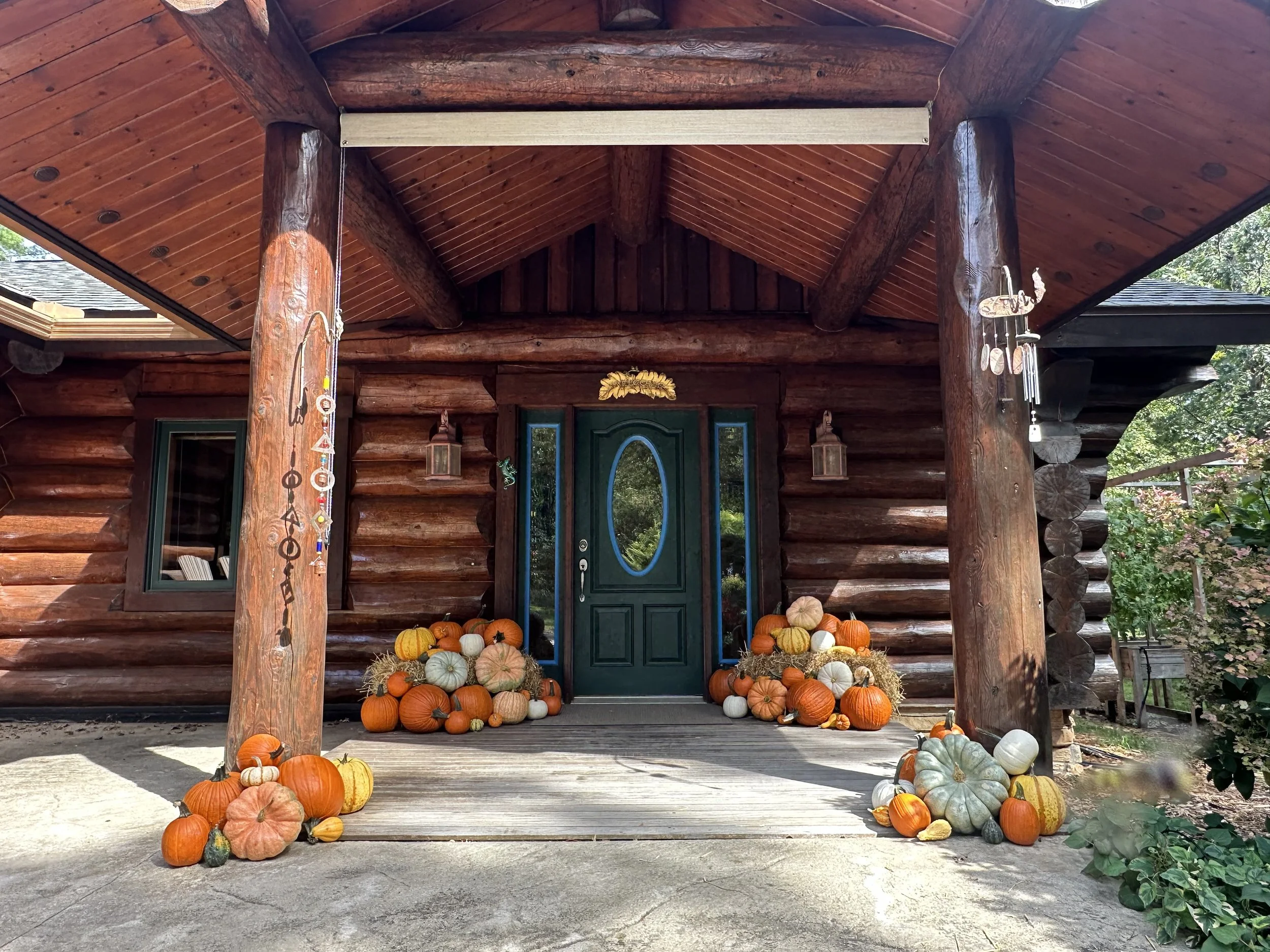 Fall decorated porch with pumpkins and haybales