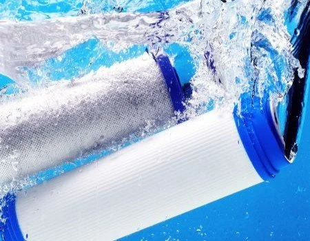 Close-up of a water filter with water splashing around it.