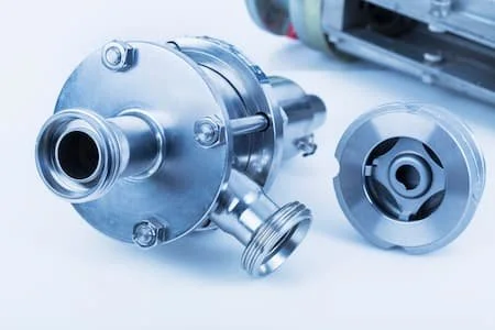 Close-up of metallic pump components on a white background.