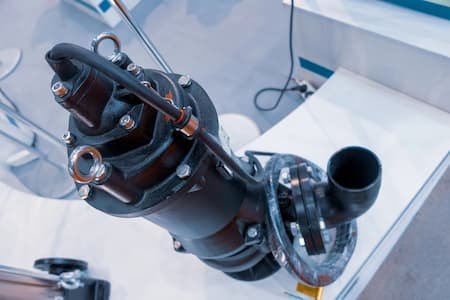 Close-up of a ship's propeller shaft and couplings on display in a showroom.