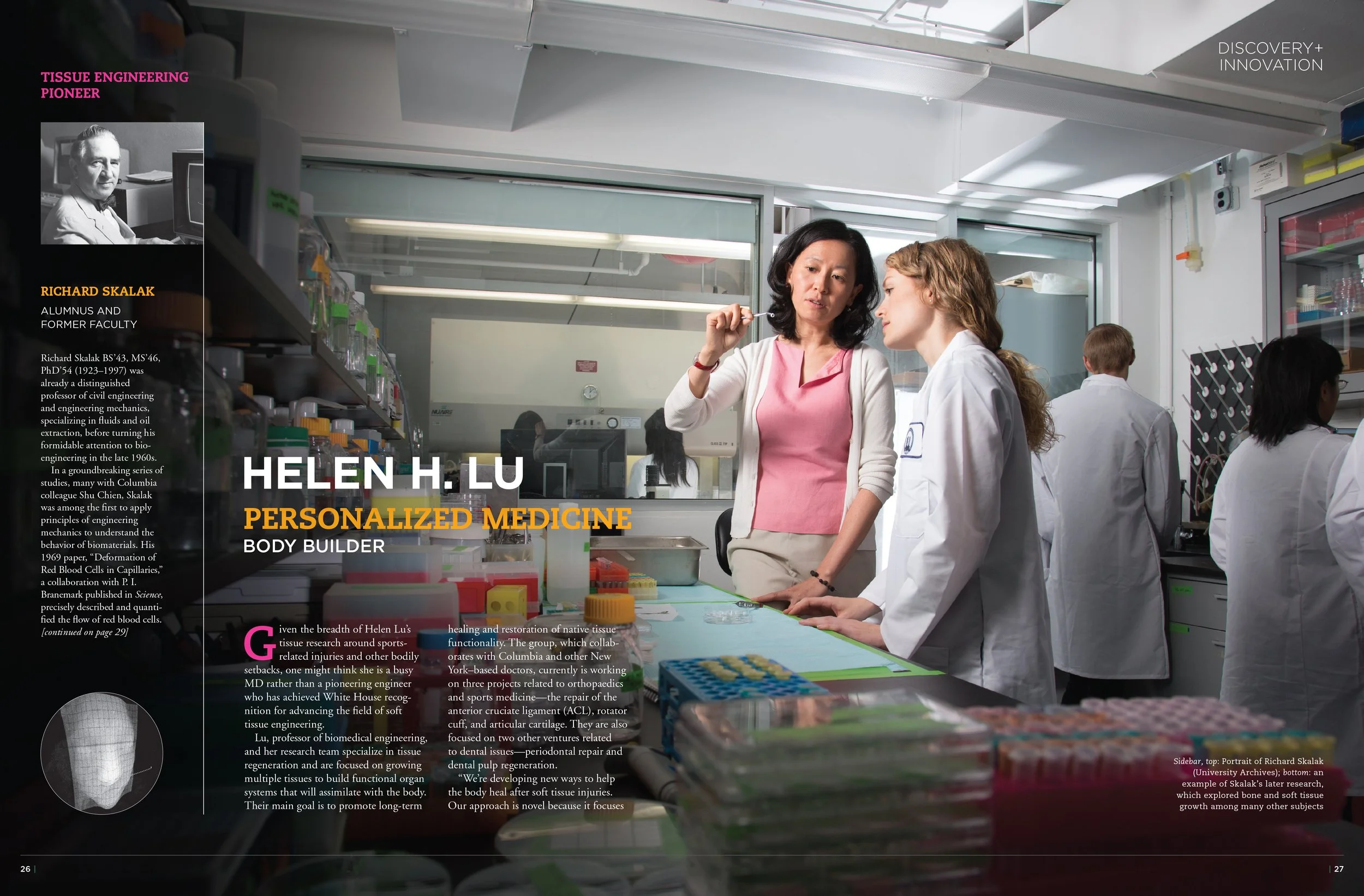 A laboratory scene with two women, one in a pink shirt and the other in a white lab coat, engaging in conversation. The lab is filled with scientific equipment, colorful test tubes, and supplies. In the background, other scientists can be seen workin