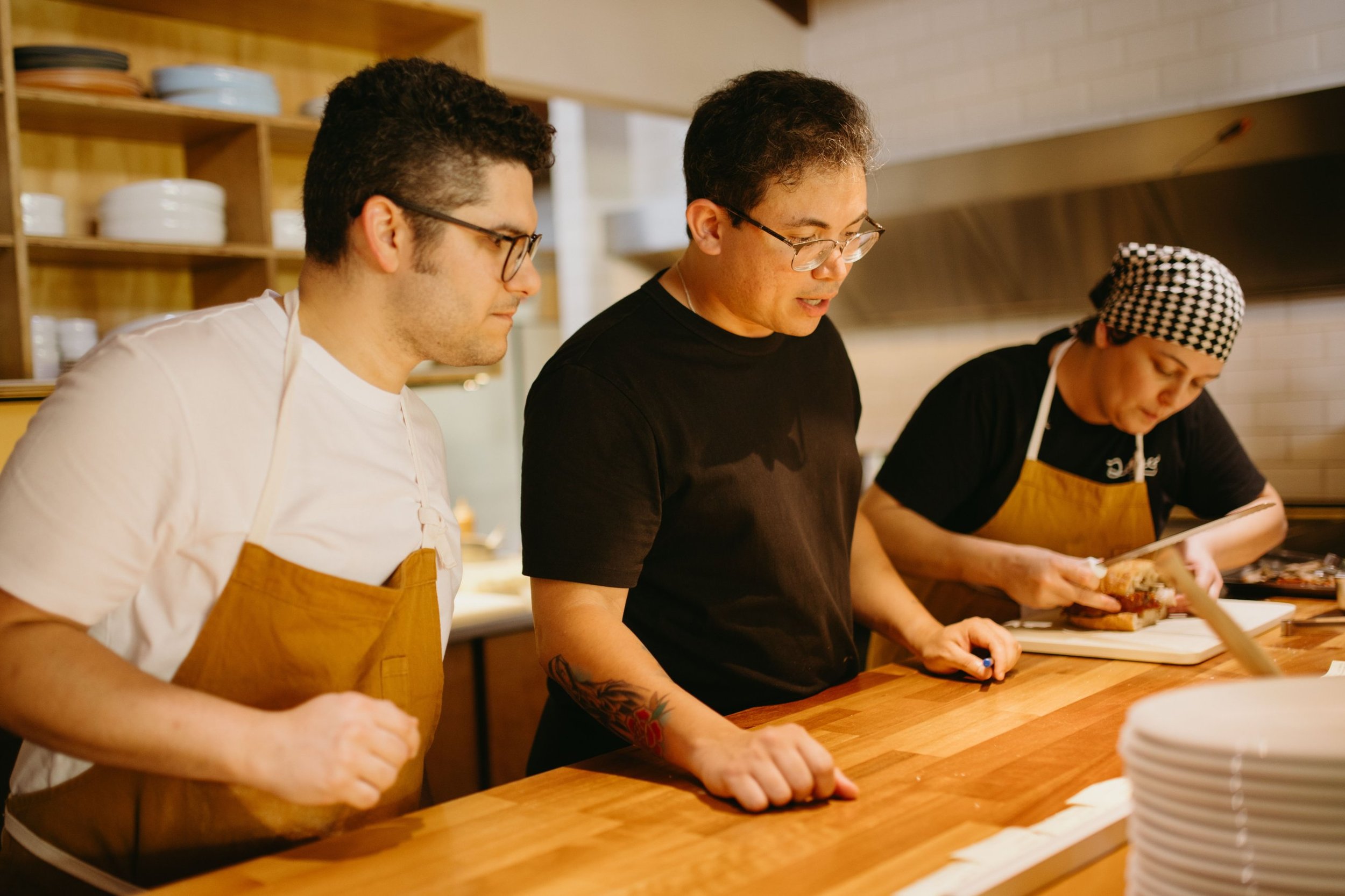 Restaurant kitchen team talking through service at the counter