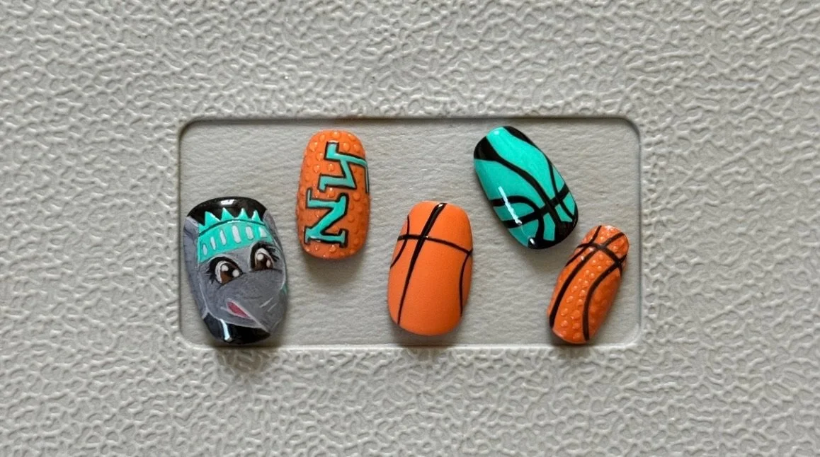 A hand-painted New York Liberty nail set was created for Amanda Mochi, a sports broadcaster featured on the Hoops and Healing Podcast.