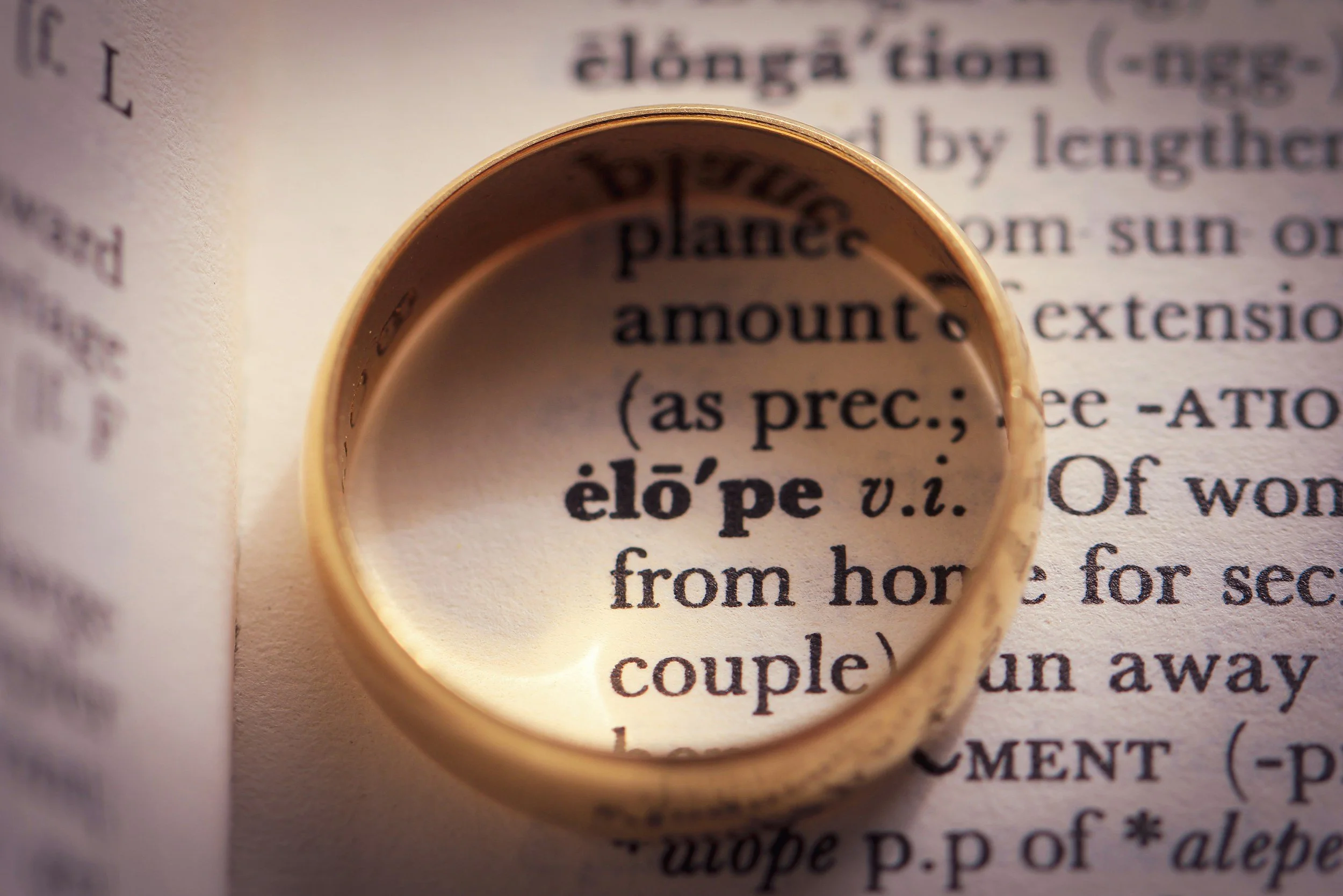 A close-up image showing a page from a book with a magnifying glass focusing on the word 'planets'.