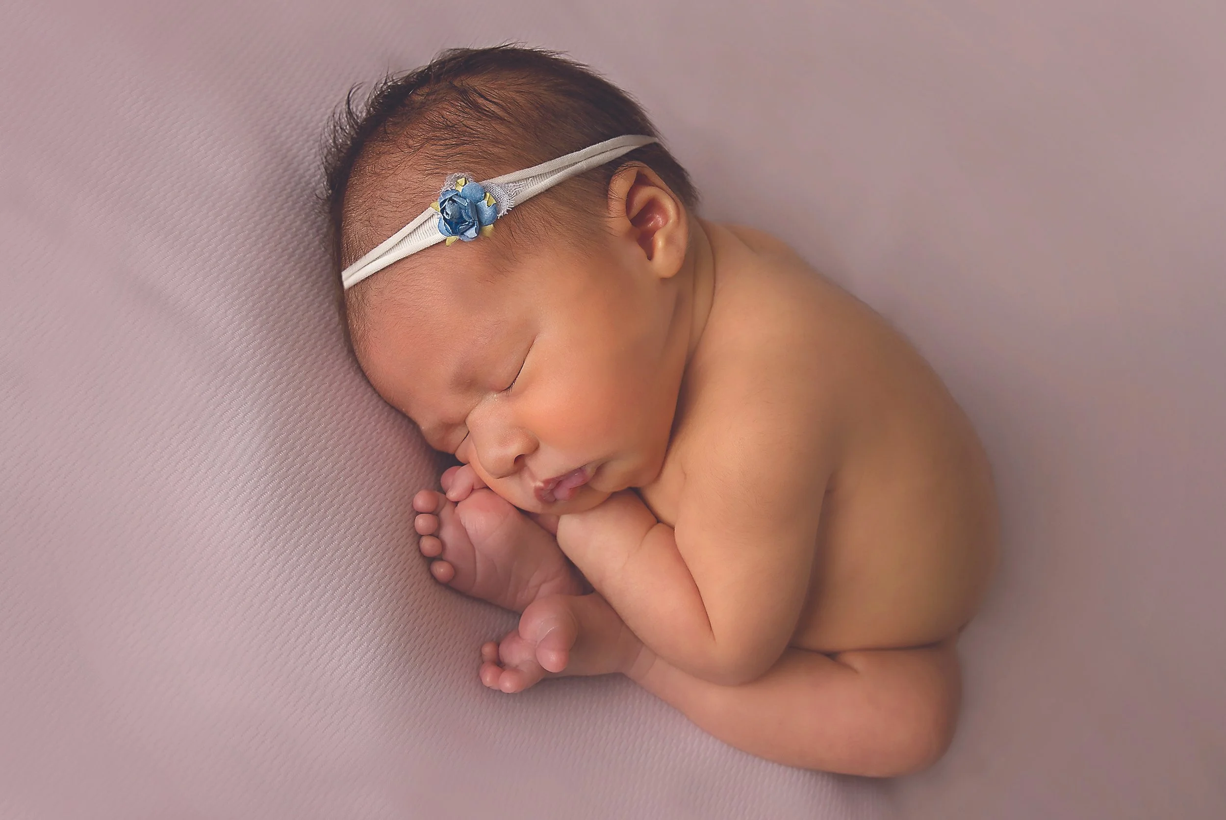 Newborn baby photo by Kitchener–Waterloo photographer Janelle Joy Studios — Clean, minimal portrait highlighting connection and calm.