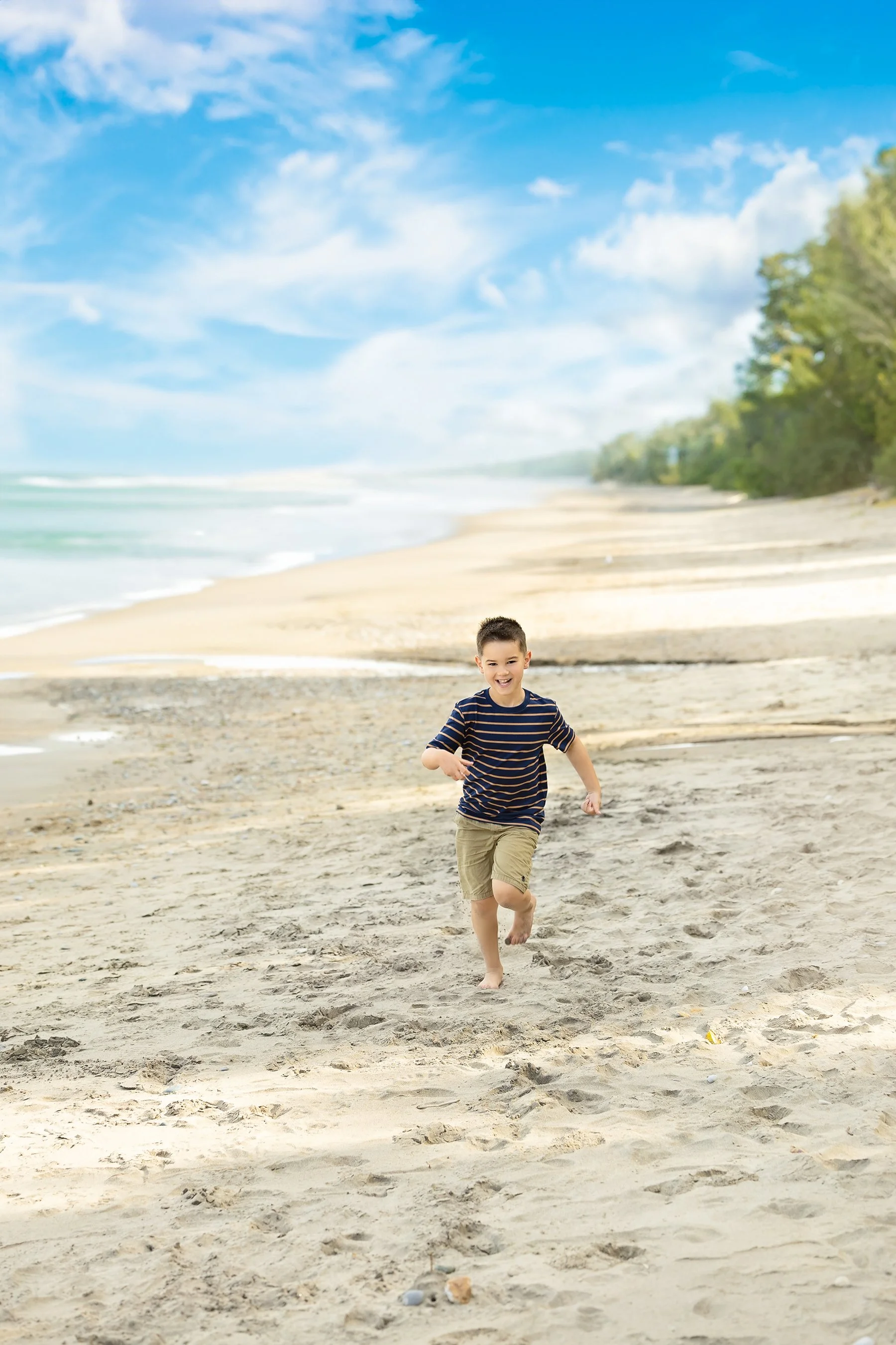 Black and white fine art beach portrait of a little boy in Kincardine, Southern Ontario by Janelle Joy Studios