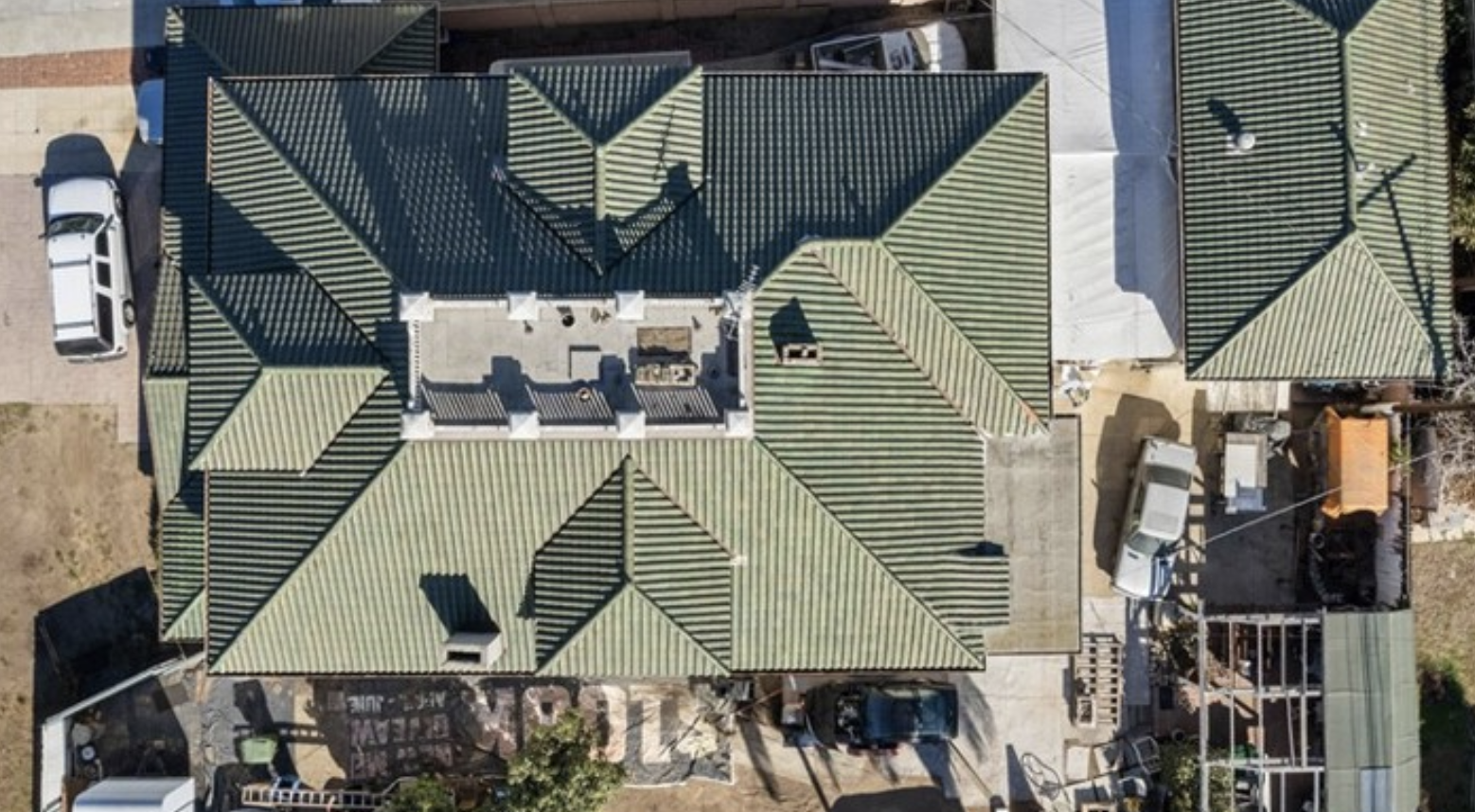 The Cunningham Residence, a 1914 Foursquare with a green tile roof and widow’s walk on South Crenshaw Boulevard in Arlington Heights.