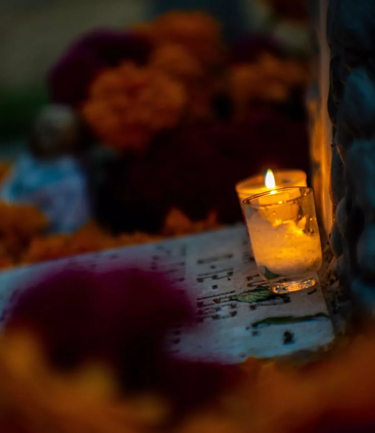 Candle at gravesite in autumn