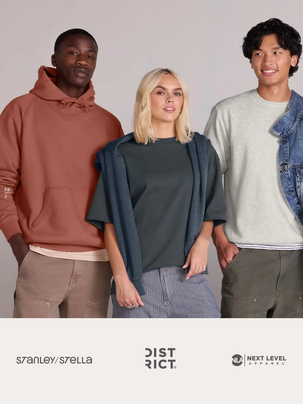 Three young adults standing together in casual clothing, with logos for Stanley/Stella, Distri, and Next Level Apparel at the bottom.