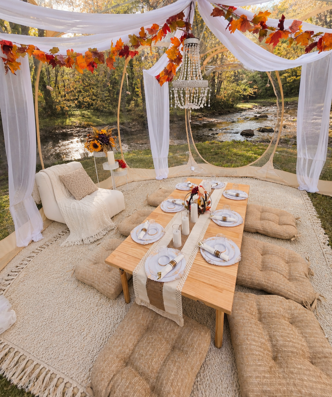 Luxury fall picnic tent in Minnesota featuring elegant décor, cozy lounge seating, floral arrangements, chandelier lighting, and a scenic riverside setting for romantic dates, anniversaries, and special celebrations.