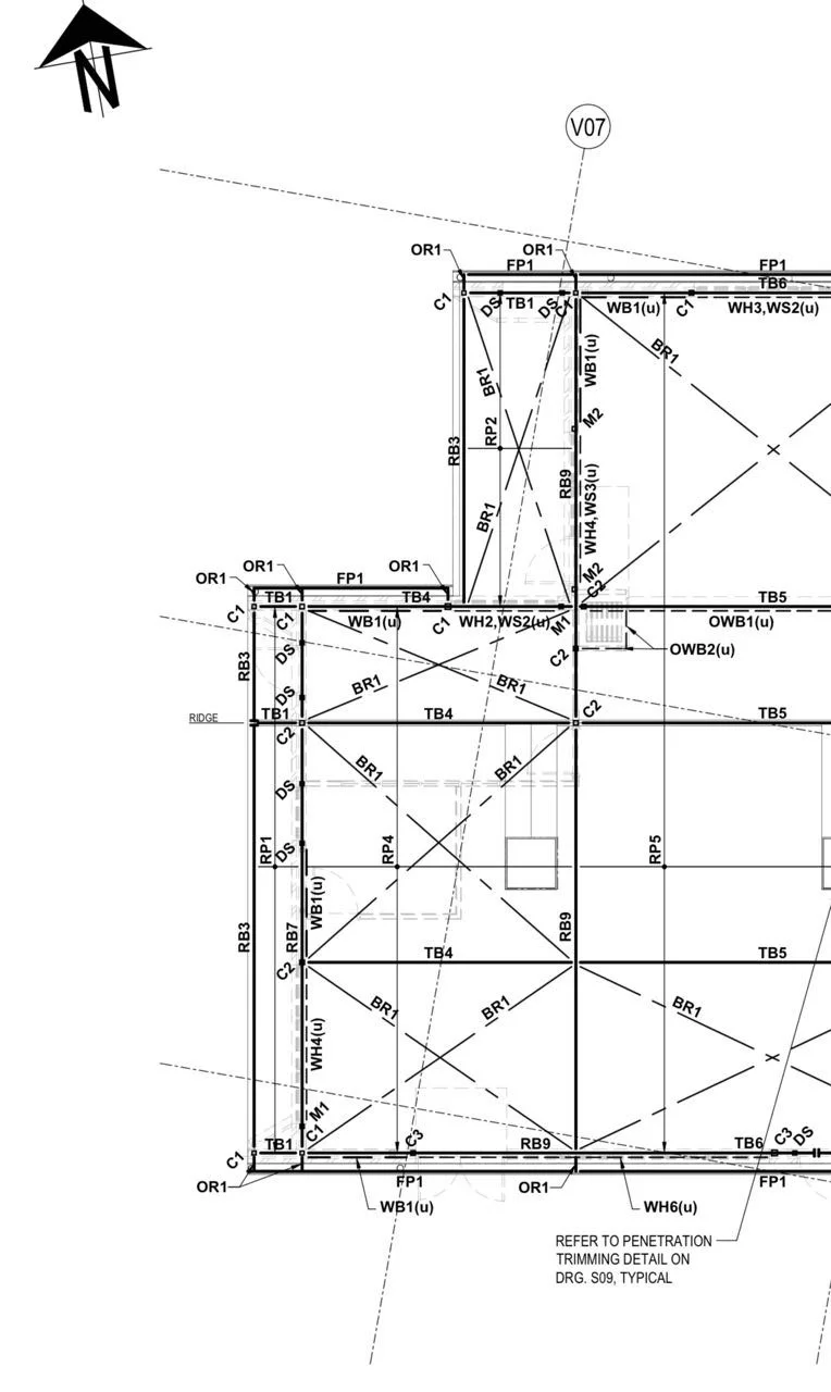 A detailed construction blueprint of a building or structure with various labeled measurements, lines, angles, and annotations for construction and design.