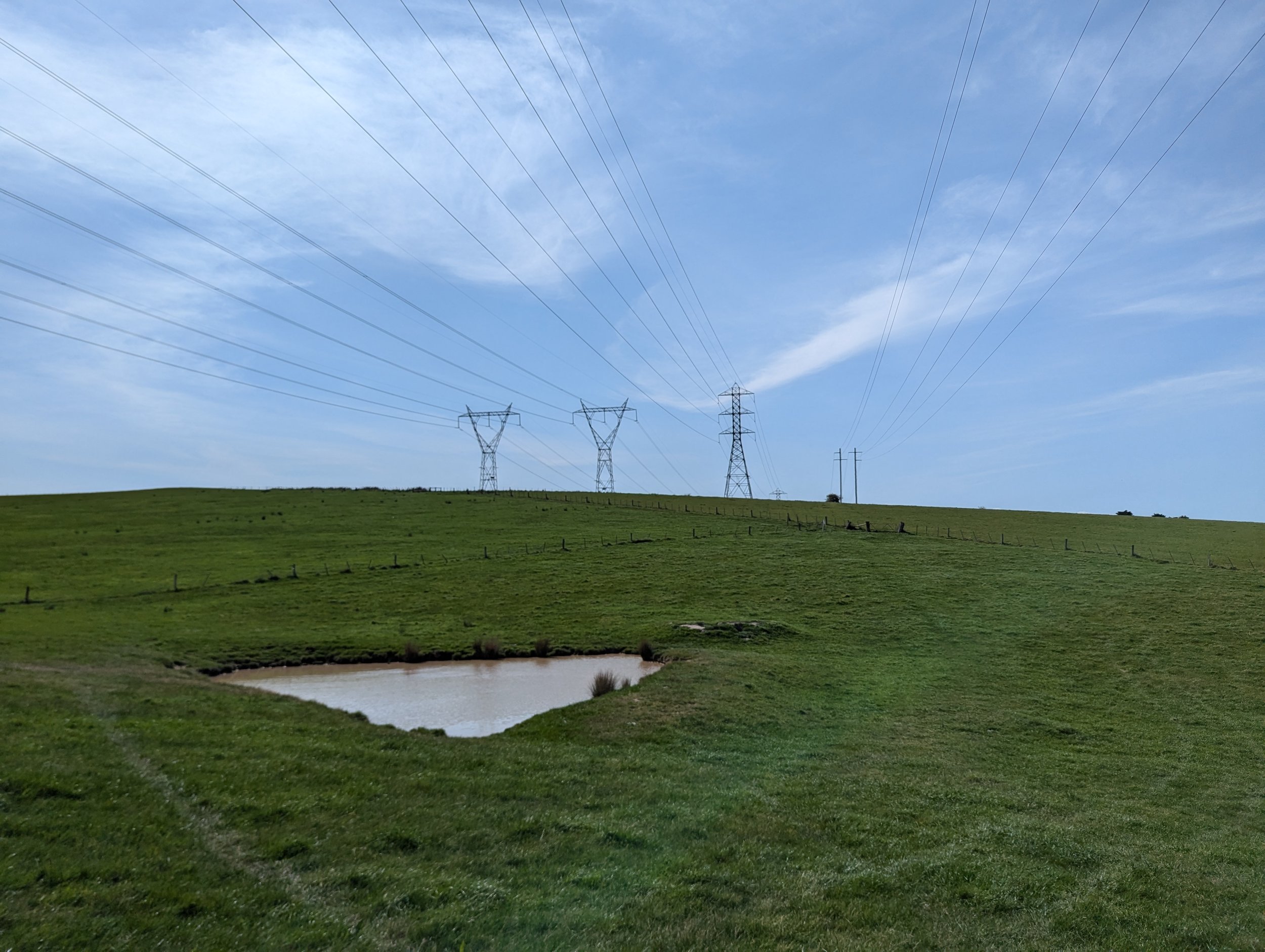 Site looking northeast towards a farming dam with the existing 220kV and 330kV transmission lines overhead
