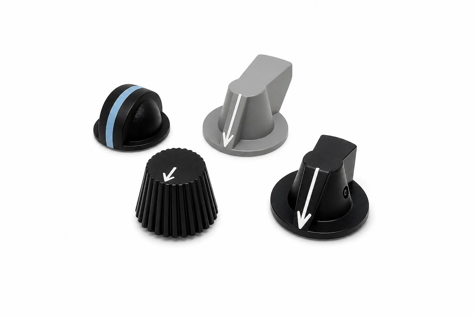A set of four adjustable control knobs and dials, including black, gray, and ribbed black-black, with white arrows indicating rotation direction.