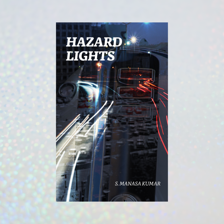 Book cover titled 'Hazard Lights' by S. Manasa Kumar featuring a city street at night with light trails from moving vehicles and traffic lights reflected in a glossy surface.