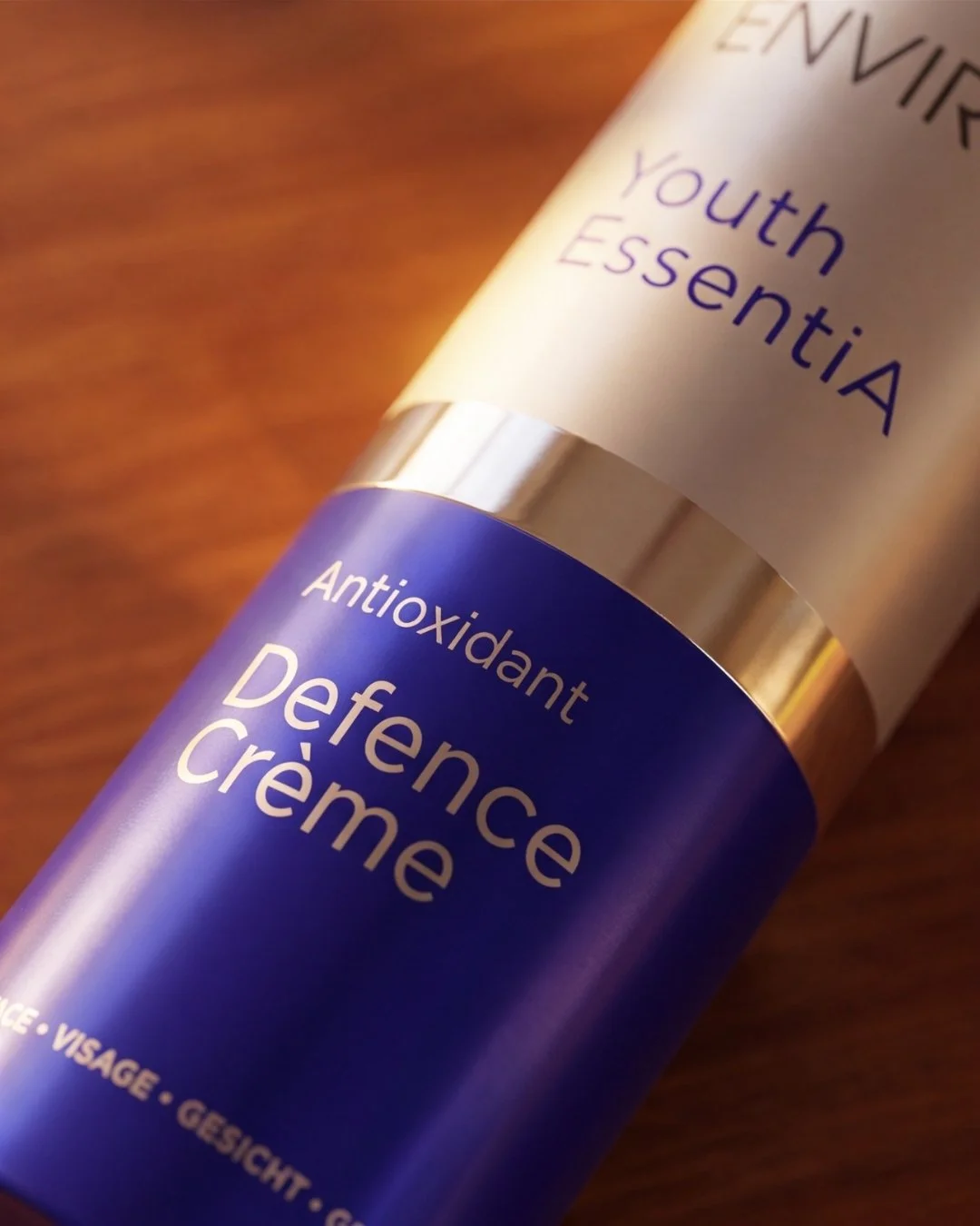 A tube of antioxidant defense crème with blue packaging and silver accents, labeled 'Youth Essential' and 'Antioxidant Defense crème'.