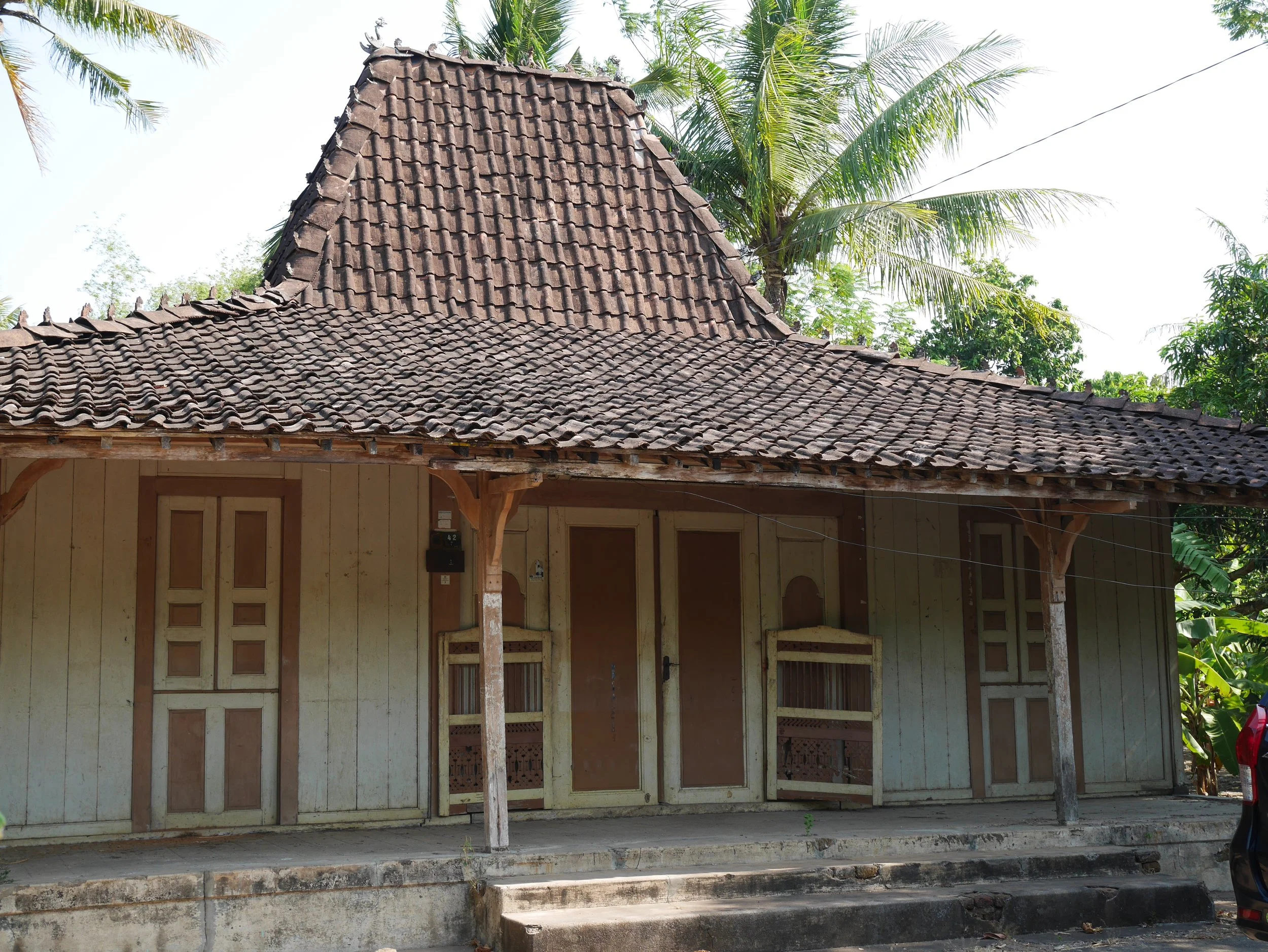 Javanese Joglo house in Kudus, Central Java, with a tiled sloped roof and wooden walls, 2015