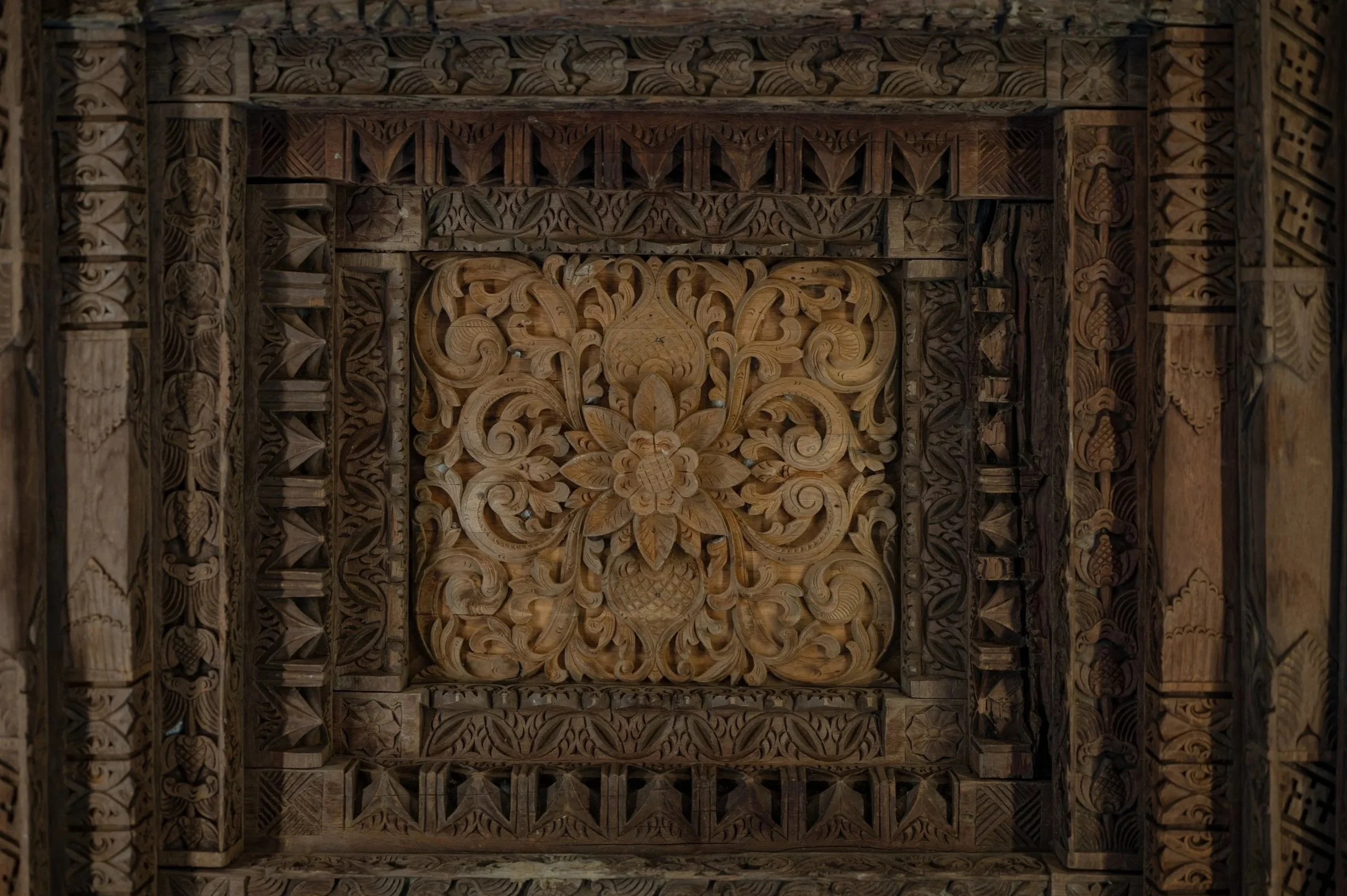 Hand-carved wooden panel with floral and geometric patterns