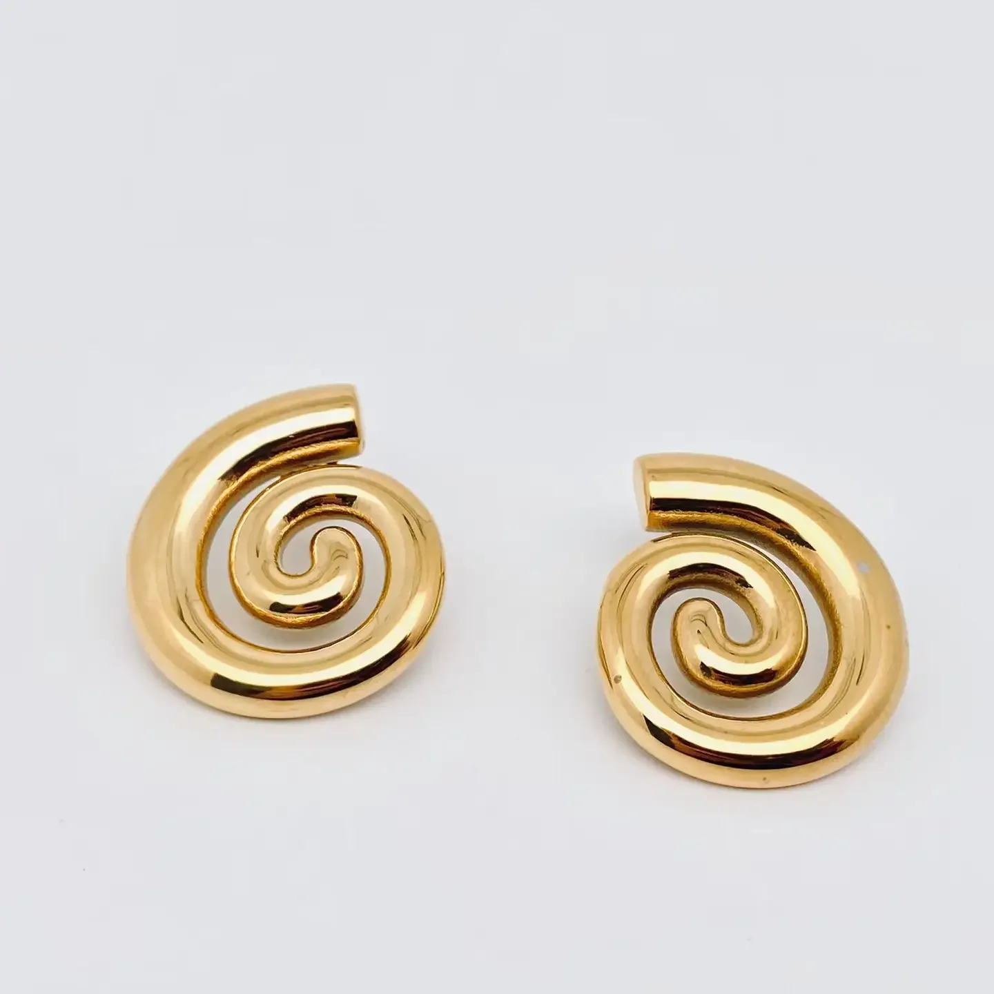 conch swirl studs 1.webp