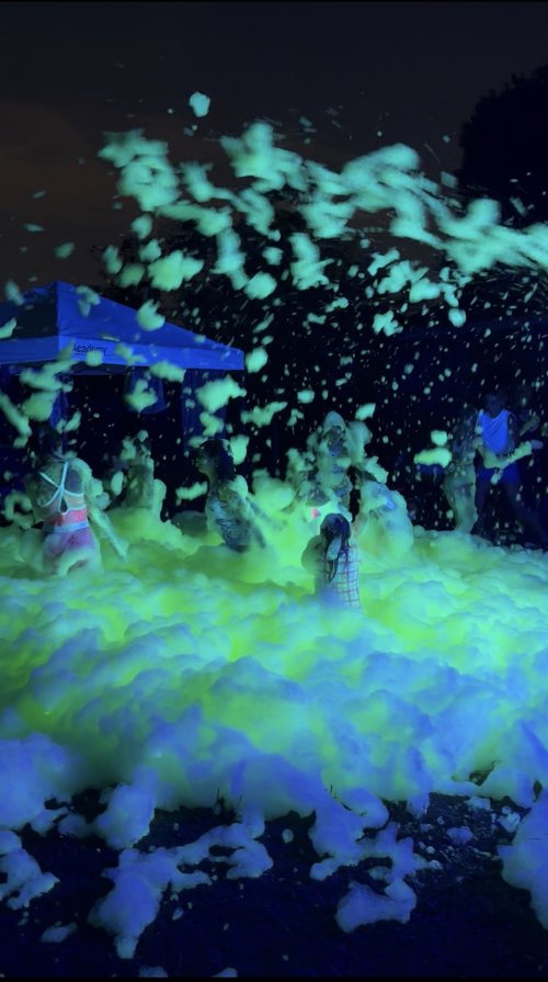 Large Foamageddon DFW crowd enjoying a nighttime foam event