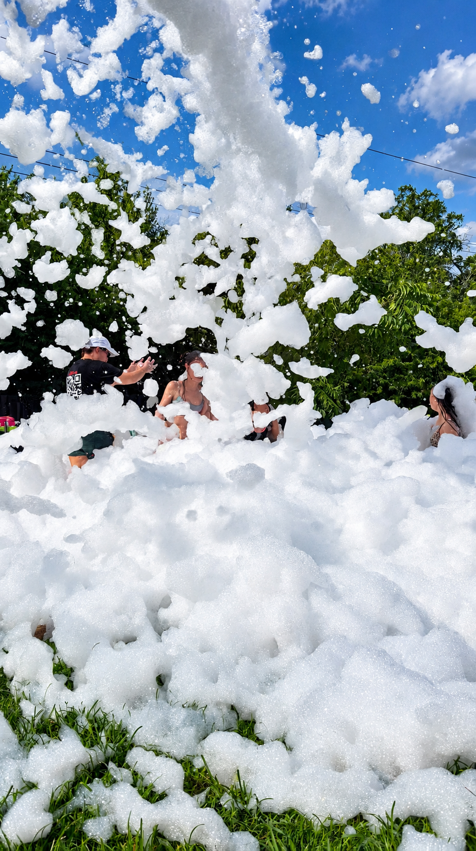 Guests surrounded by mountains of foam at a Foamageddon DFW foam party