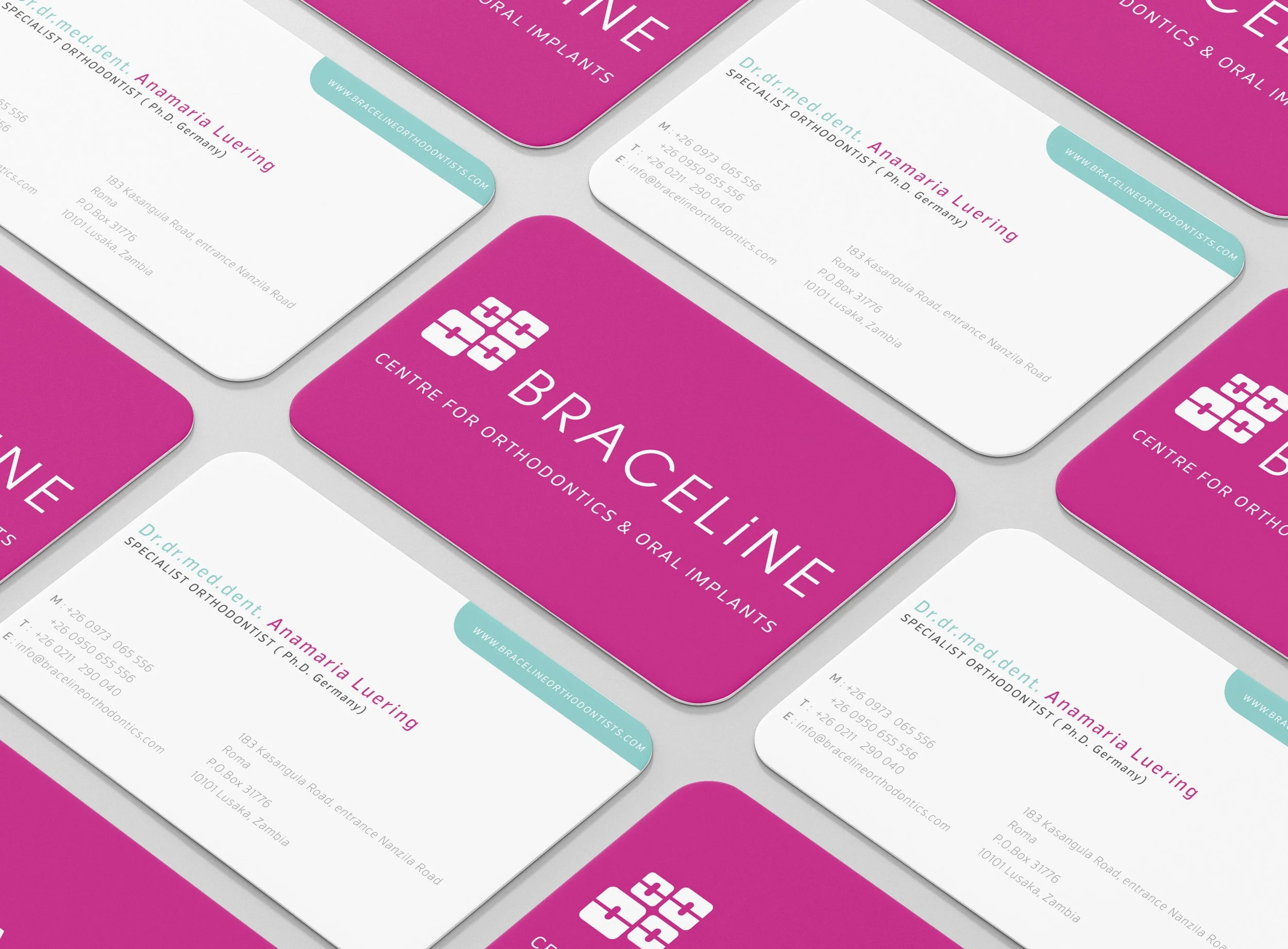 A collection of business cards for a dental clinic called BraceLine Centre for Orthodontics & Oral Implants. The cards feature a pink and white color scheme, with contact information and a logo consisting of a stylized cross made of four interlocking