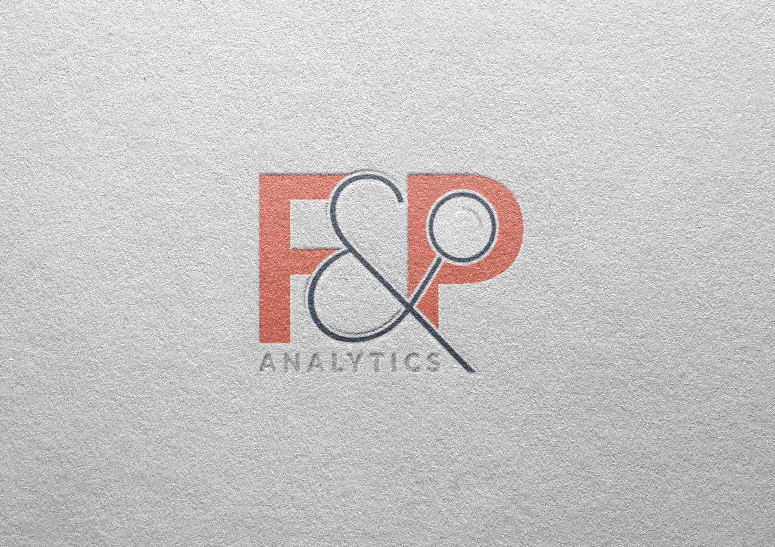 Close-up of a logo for E&A Analytics on textured paper