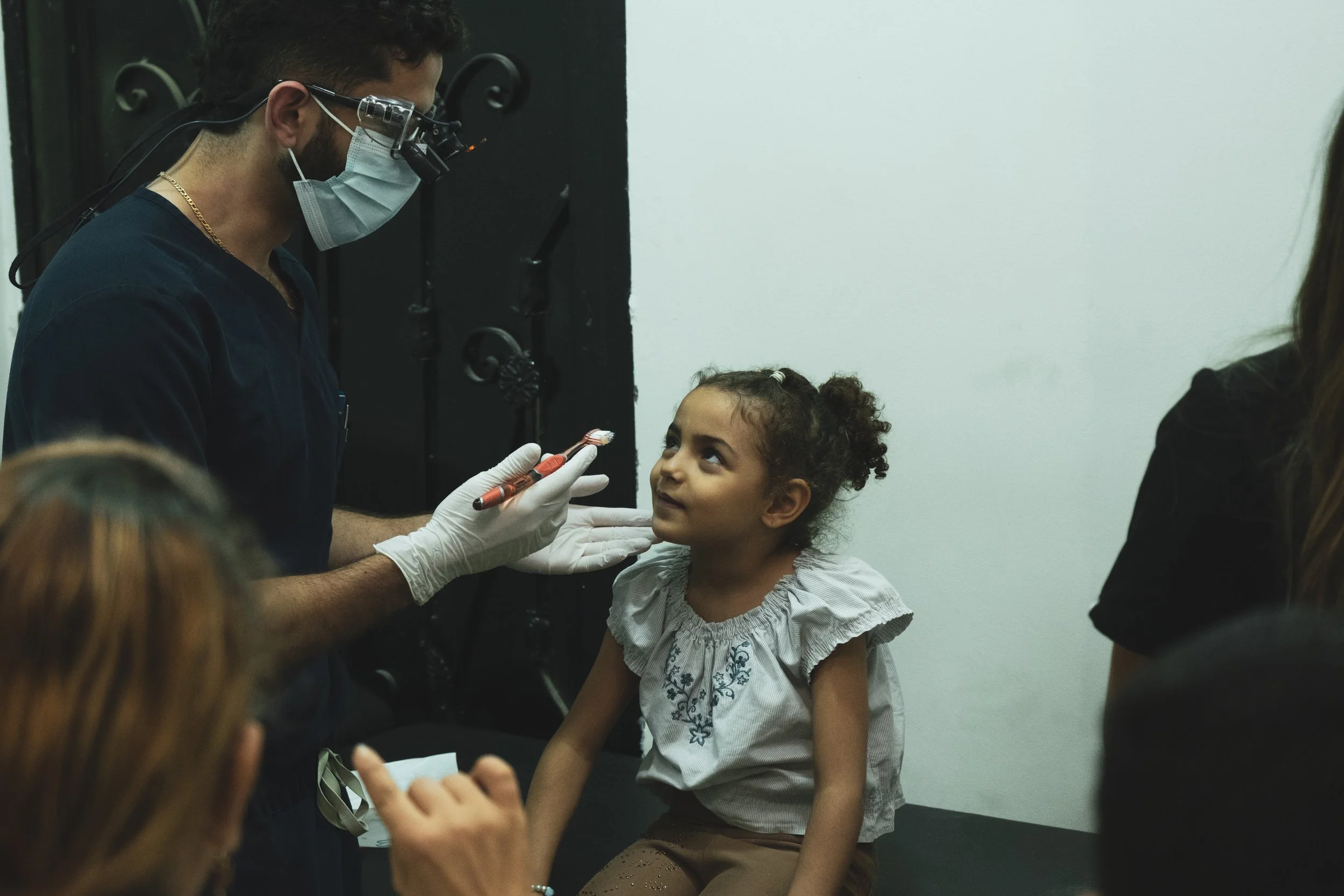 Volunteer dentist providing treatment to a child during a CMANA dental mission in Egypt.