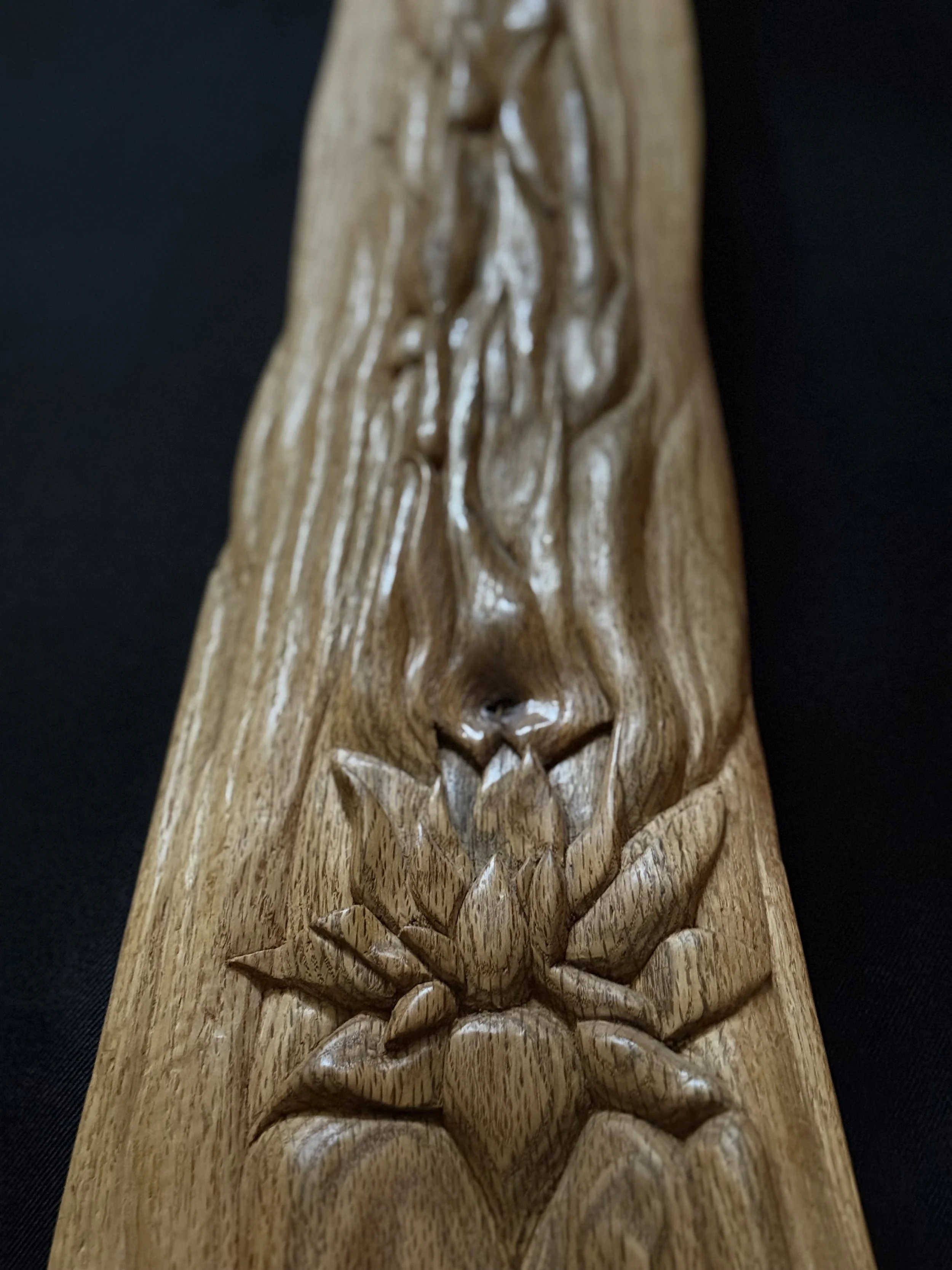 Detailed view of a chiseled lotus flower motif on a hand-carved modern wood sculpture by BeckerDzine in Kansas City.