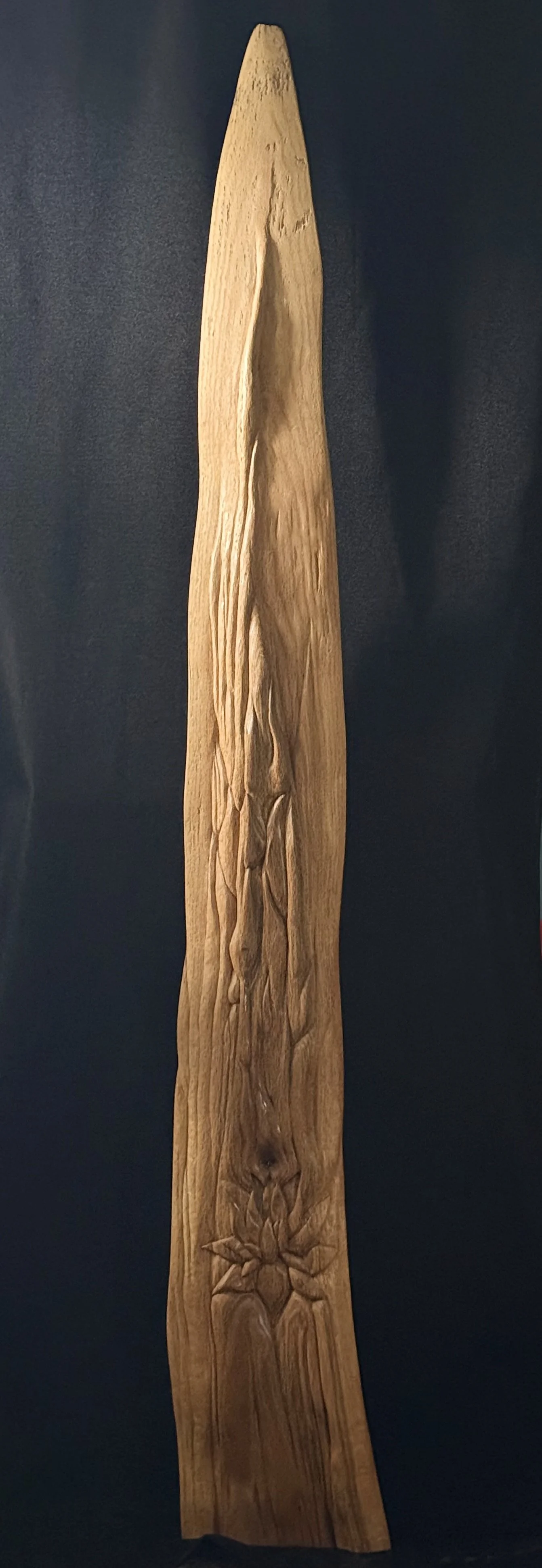 Upright view of hand-carved wood sculpture with chiseled lotus flower motif by BeckerDzine.