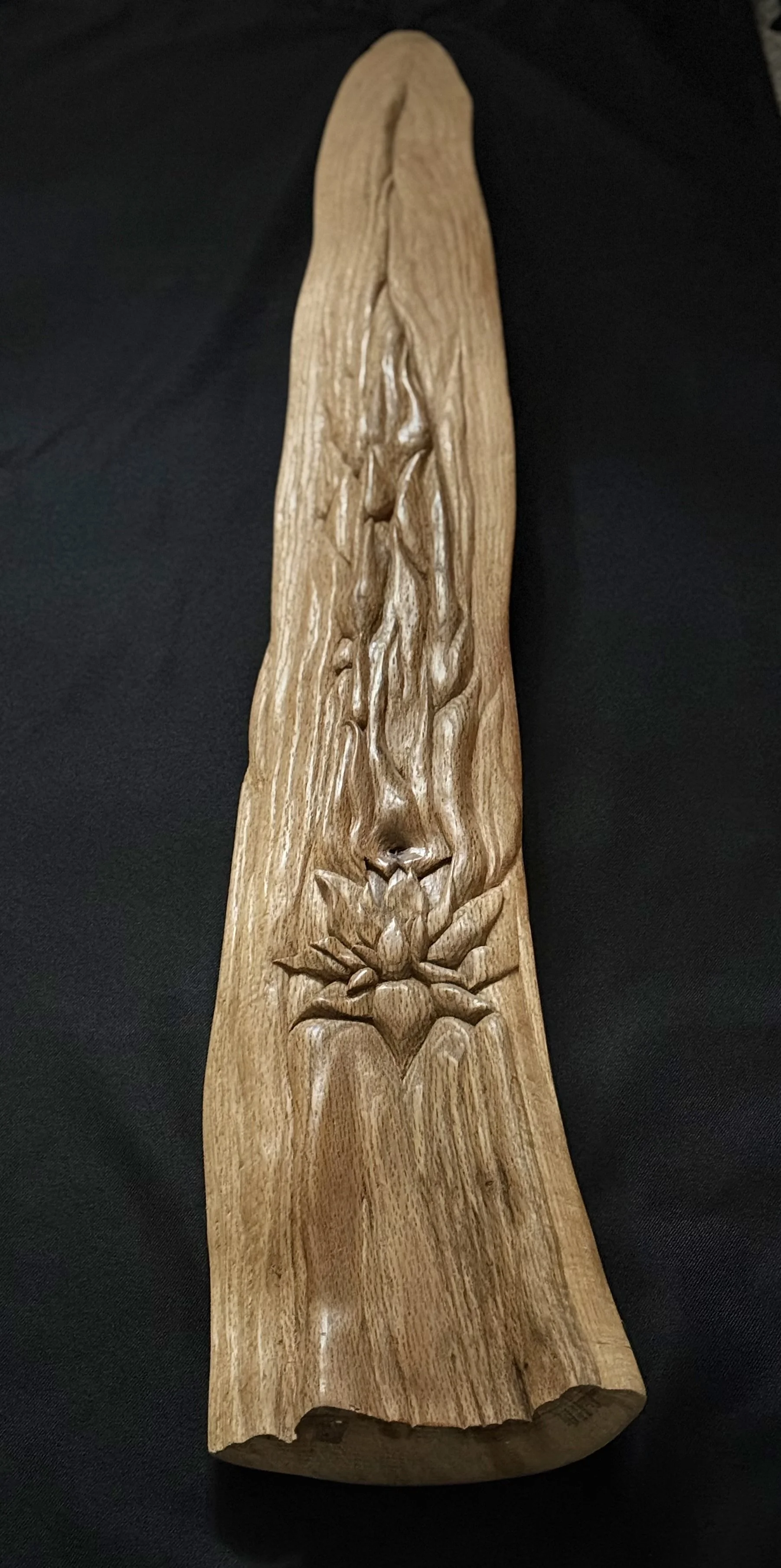Overhead view of a hand-carved modern wood sculpture highlighting detailed chiseled lotus flower motif by BeckerDzine in Kansas City. 