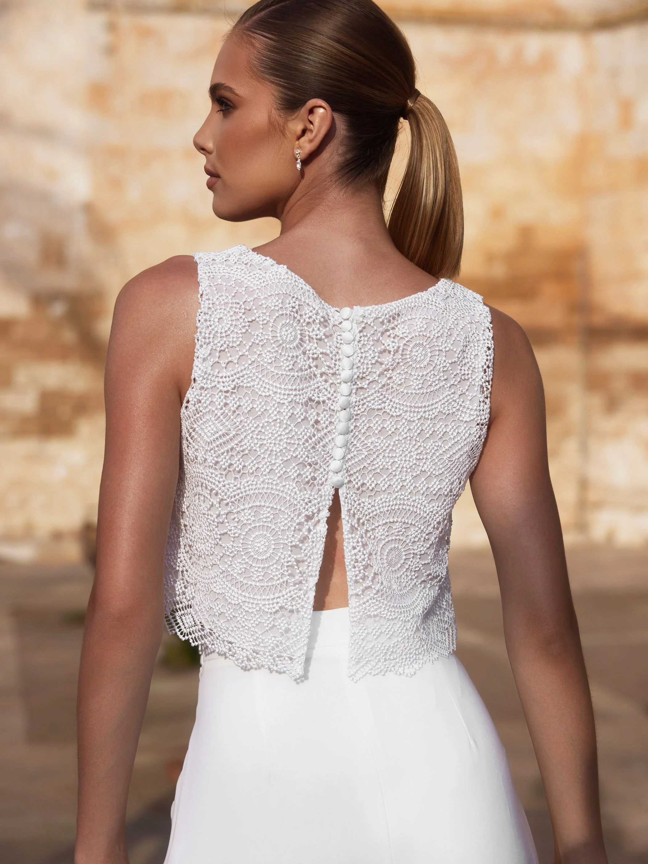 Lined back of bridal bodice showing semi split and button detail