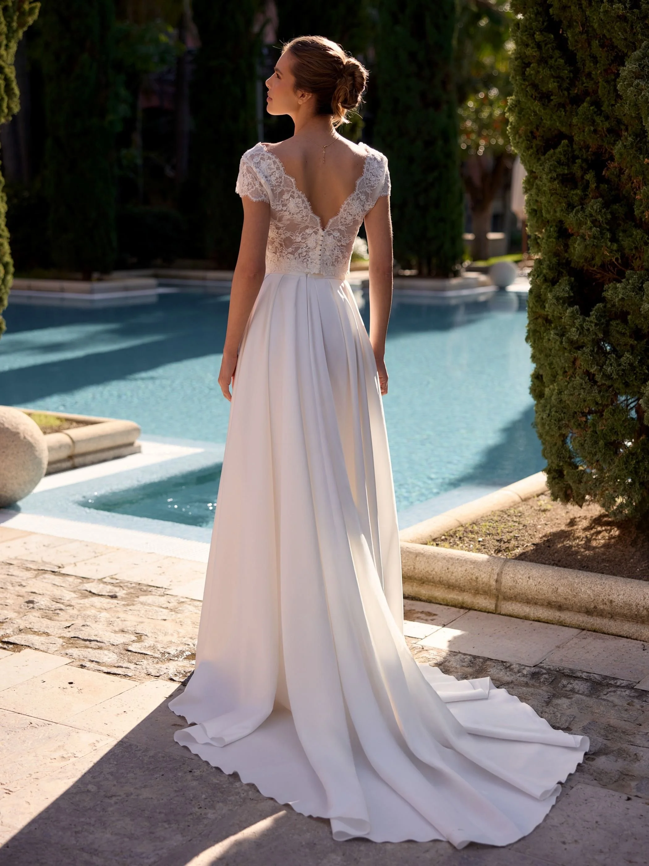 Composed with lace top back.Composed bridal skirt of lux satin with generous train and box pleats